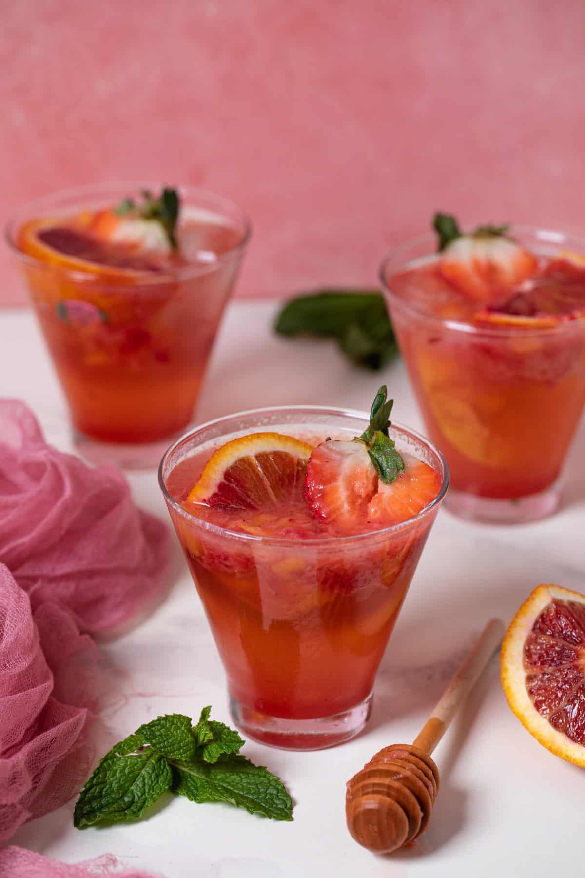 Three glasses of Blood Orange Strawberry Ginger Mocktail.