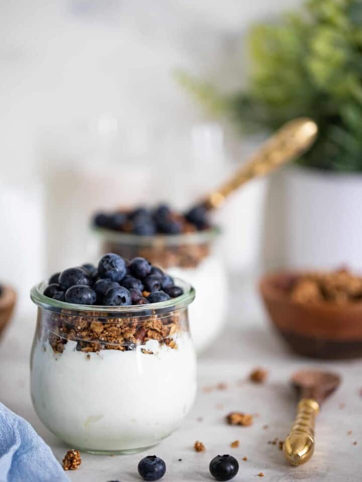 Blueberry Granola Yogurt Breakfast Parfait in a small glass.