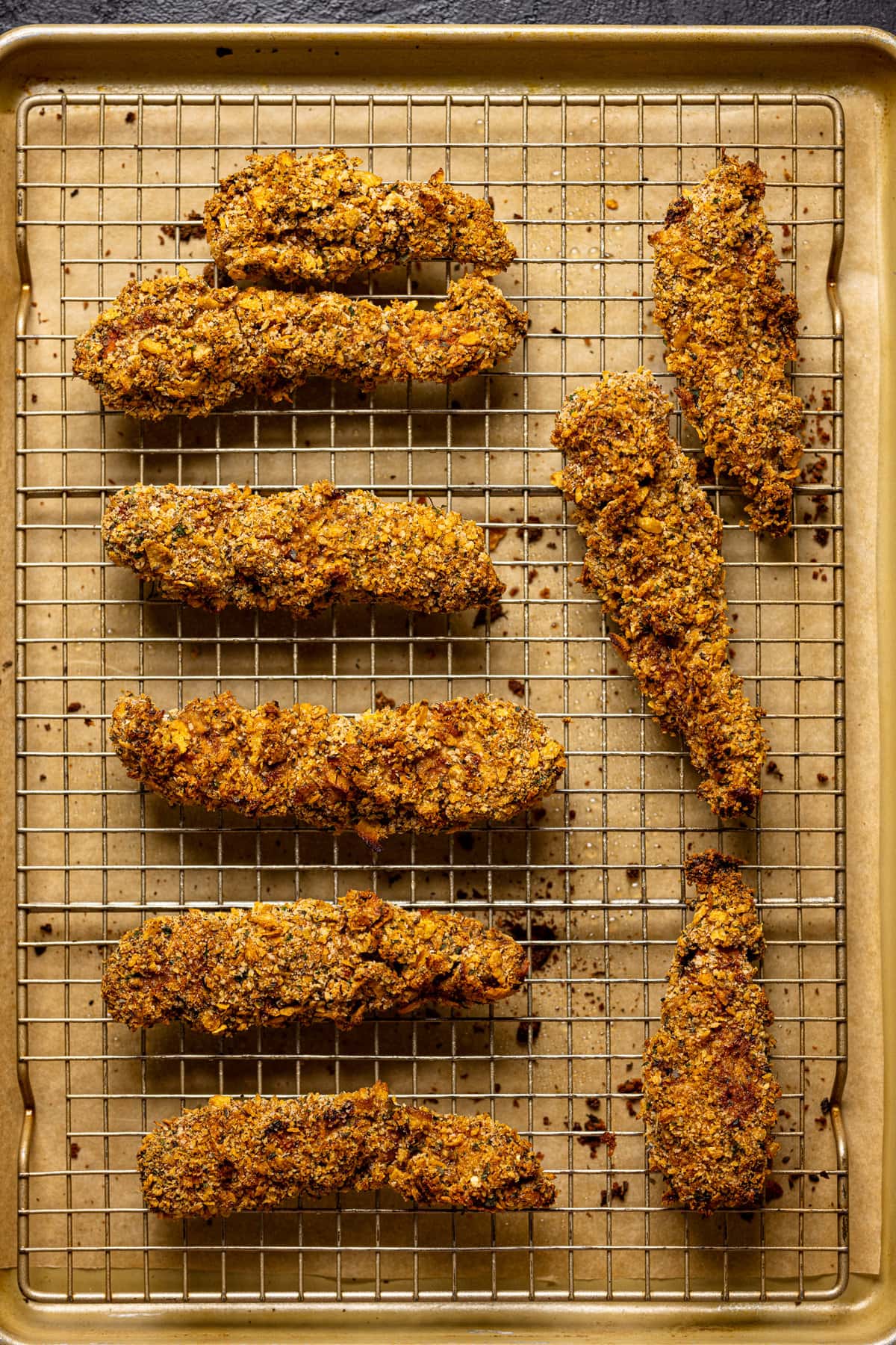 Cooked Crispy Buffalo Chicken Tenders on a wire rack.