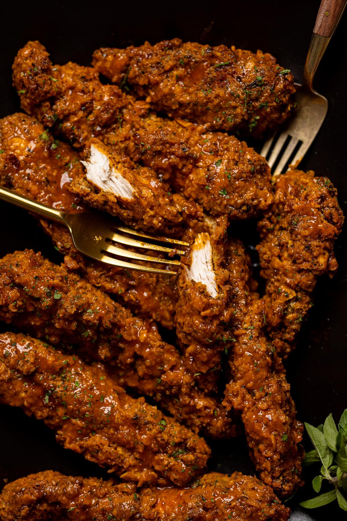 Crispy Buffalo Chicken Tenders and forks on a plate.