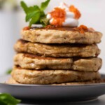 Vegan Carrot Cake Pancakes stacked on a plate.