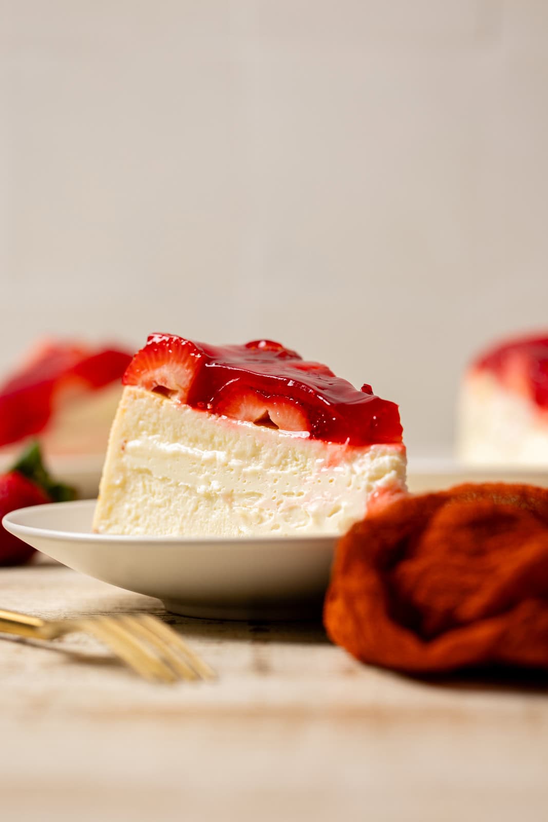Strawberry cheesecake slices on a plate.