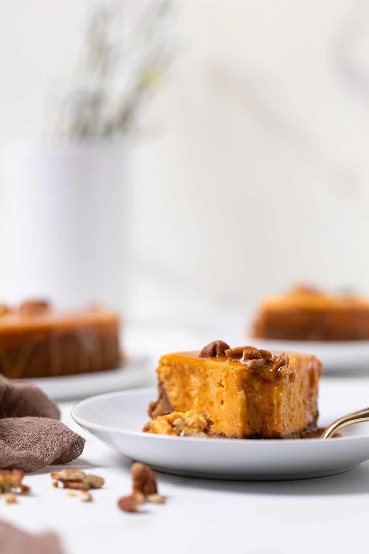 Slice of Sweet Potato Caramel Cheesecake on a plate with a fork.