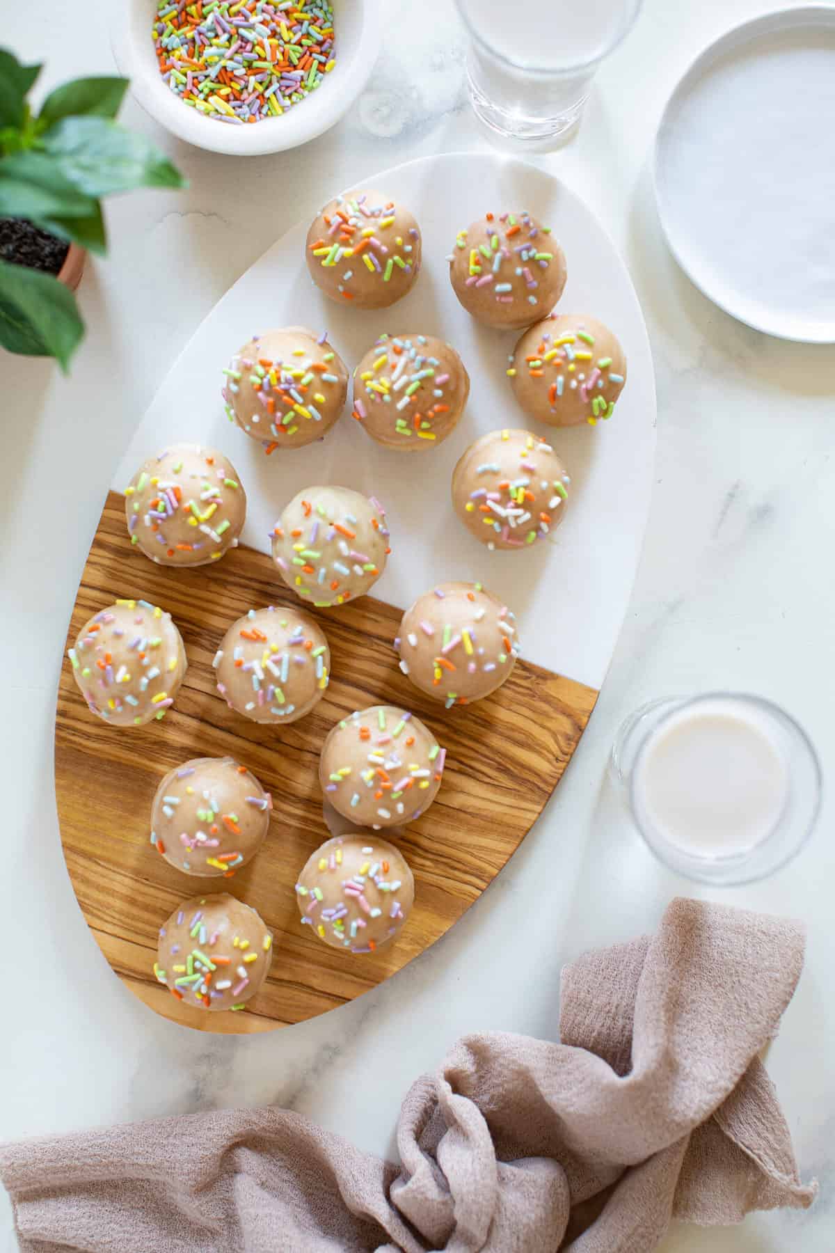 Vegan Sprinkle Donut Holes on a cutting board.