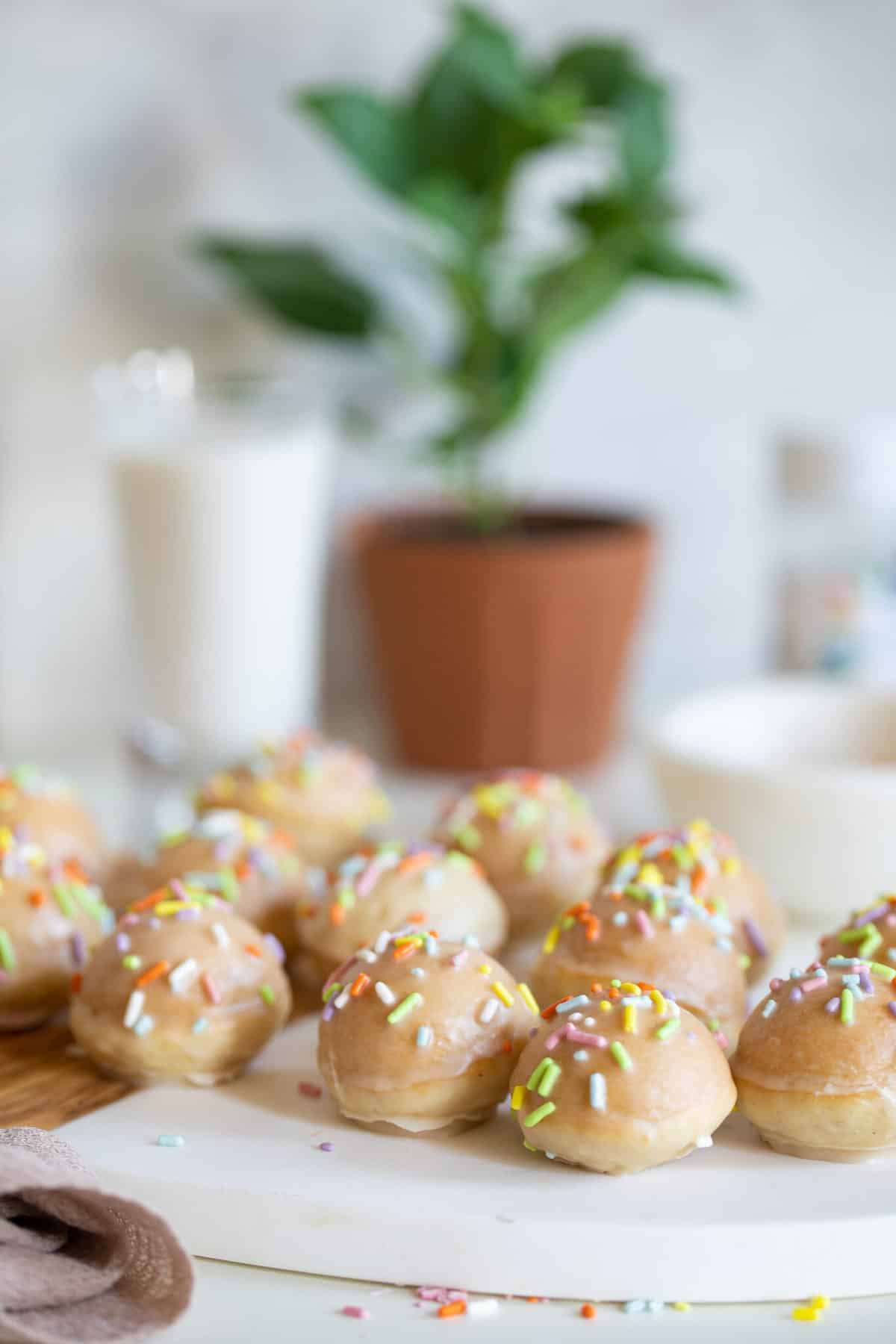 Vegan Sprinkle Donut Holes arranged on a cutting board.