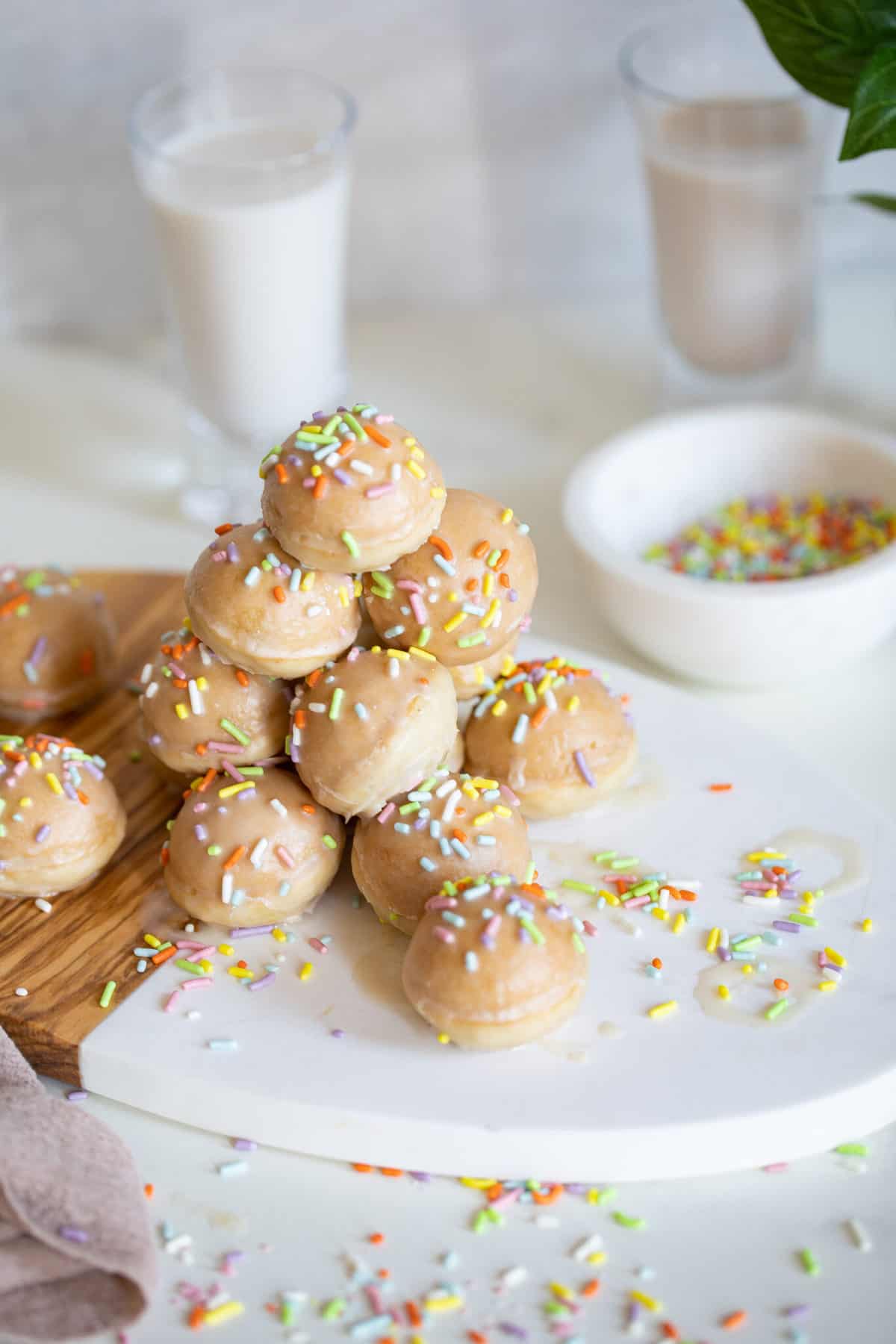 Stack of vegan donut holes with rainbow sprinkles.