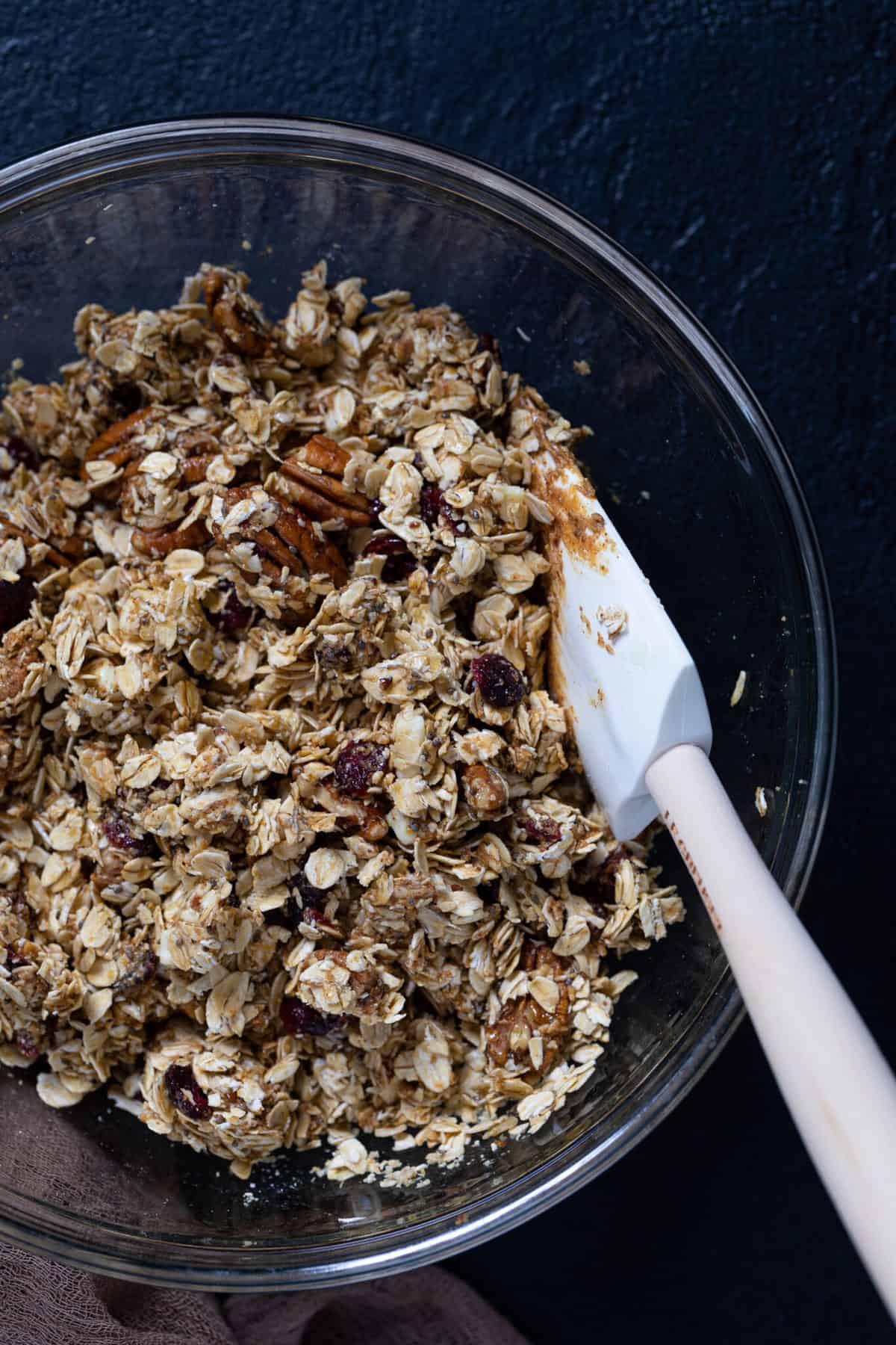 Overhead shot of the dough for White Chocolate Cranberry Energy Bites in a glass mixing bowl.