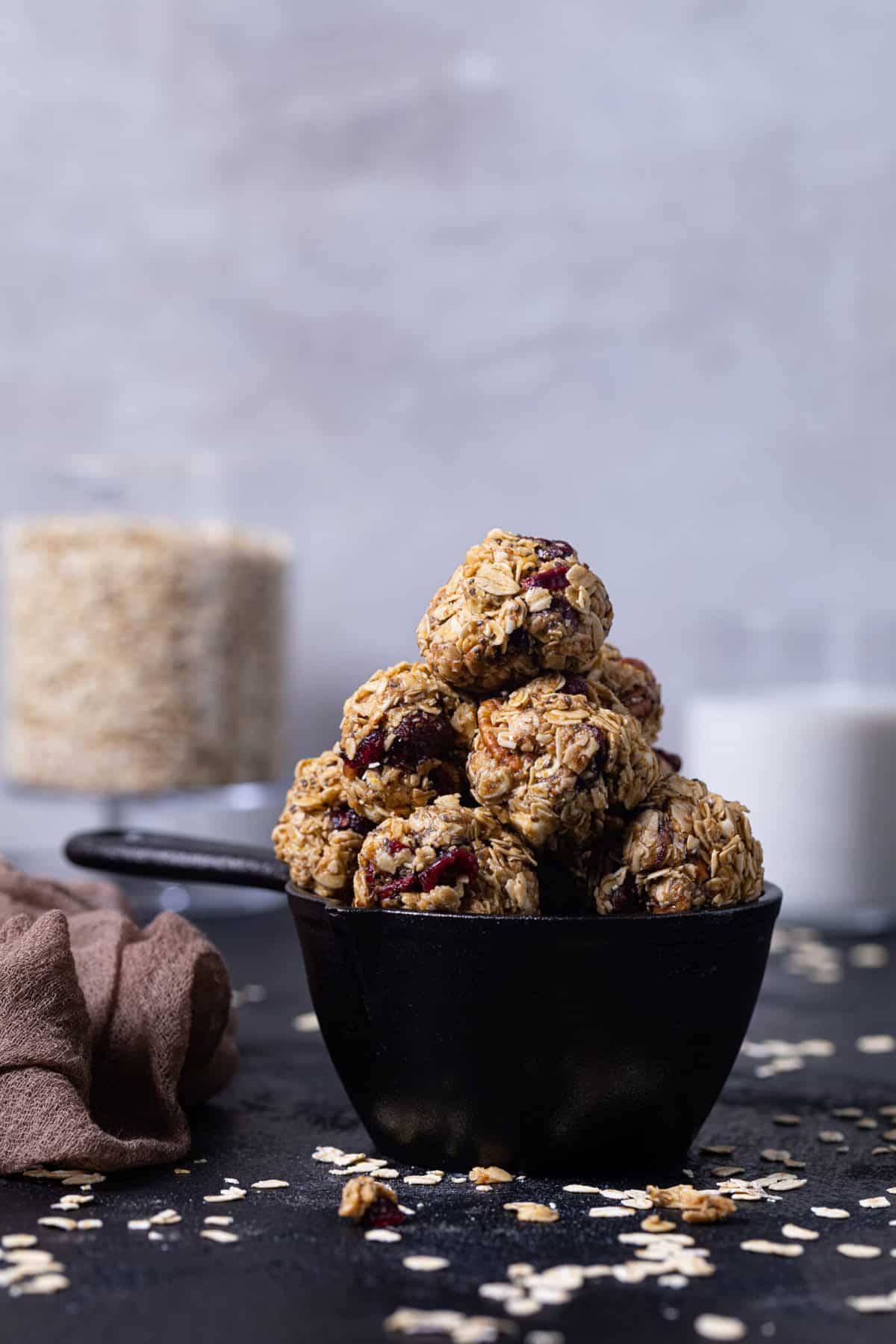 White Chocolate Cranberry Energy Bites in a black measuring cup.