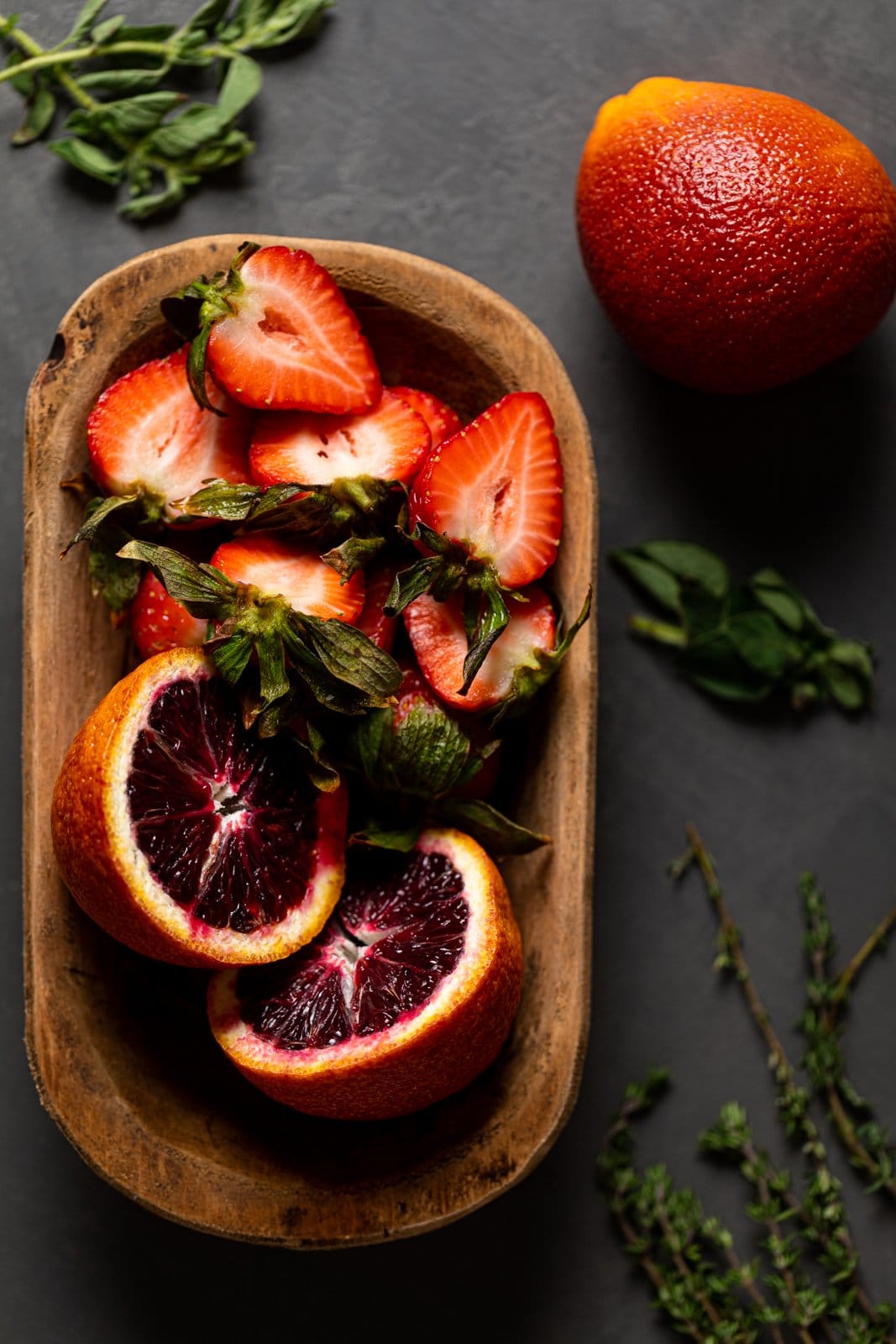 Bowl of halved strawberries and blood orange