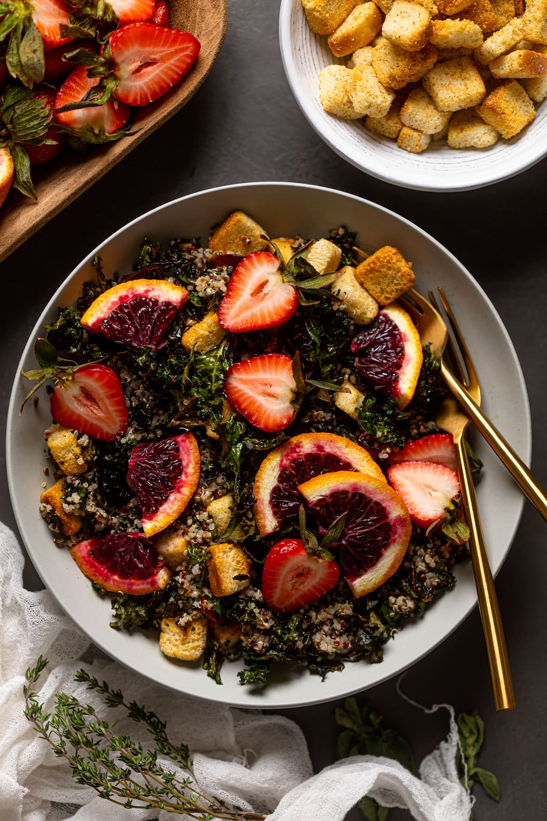 Overhead shot of a bowl of Blood Orange Kale Salad with two forks