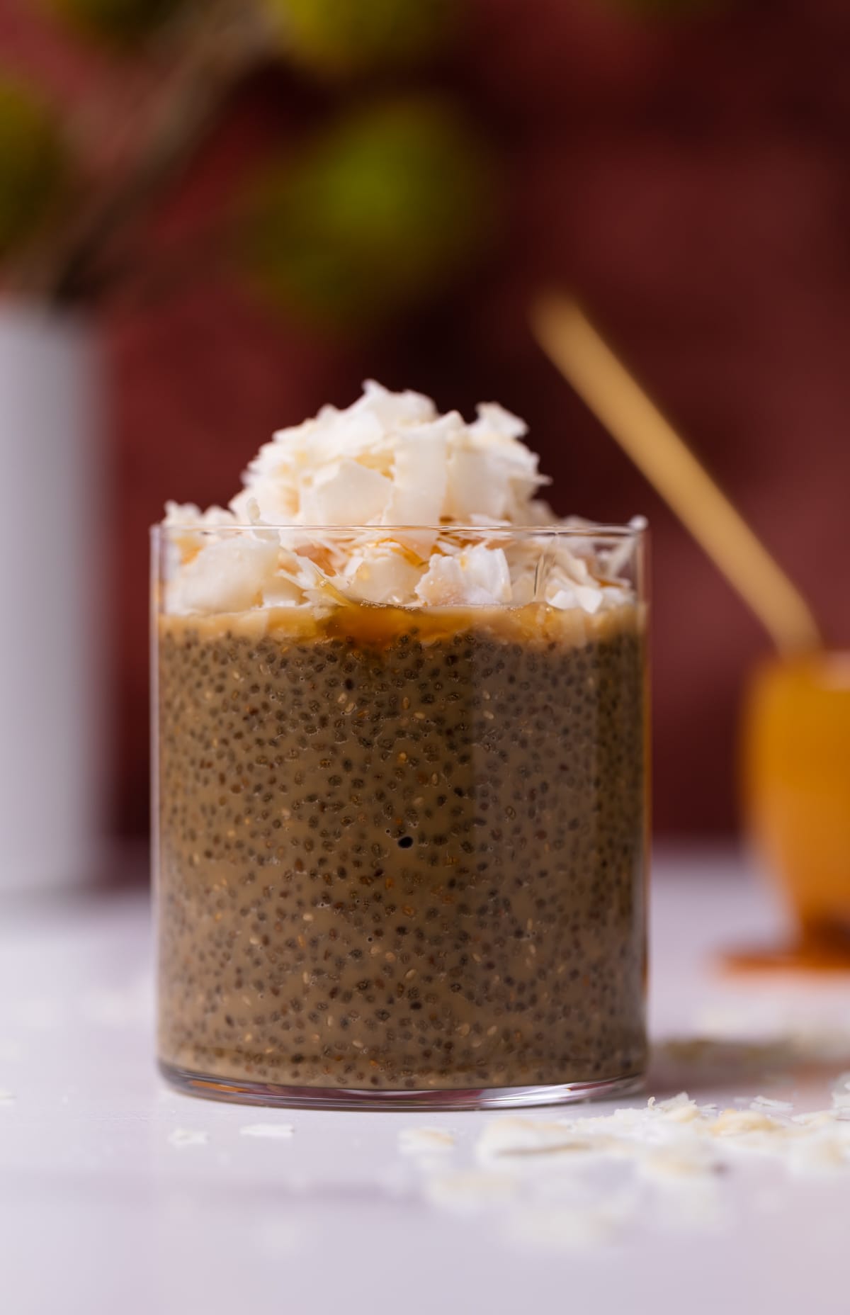 Pudding in a glass topped with coconut.