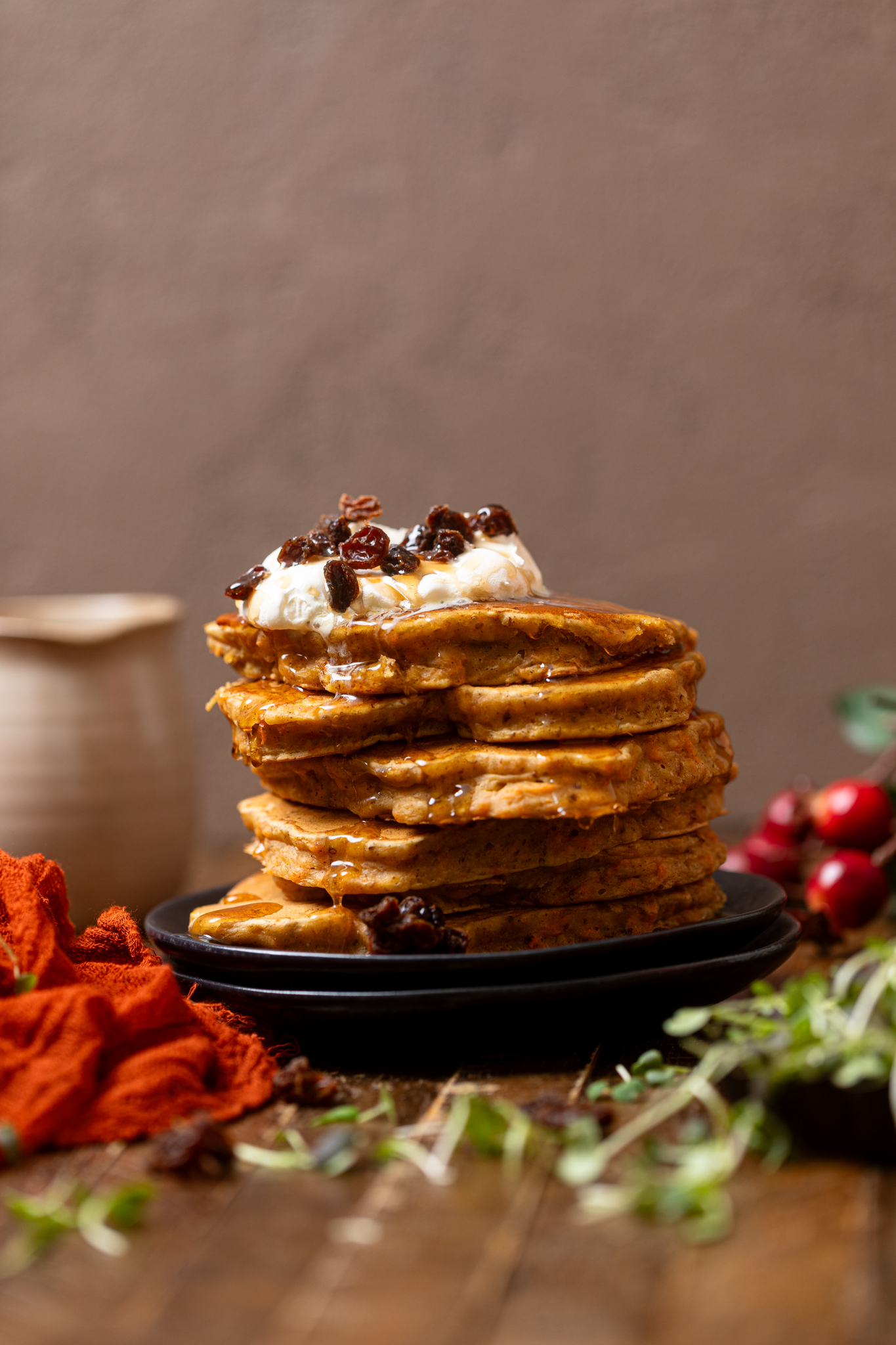 The Best Vegan Carrot Cake Pancakes stacked with toppings.