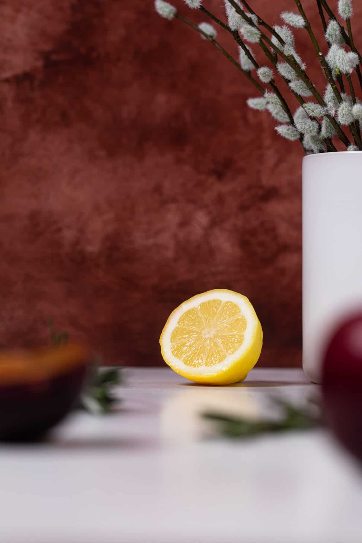 Half of a lemon on a white table.