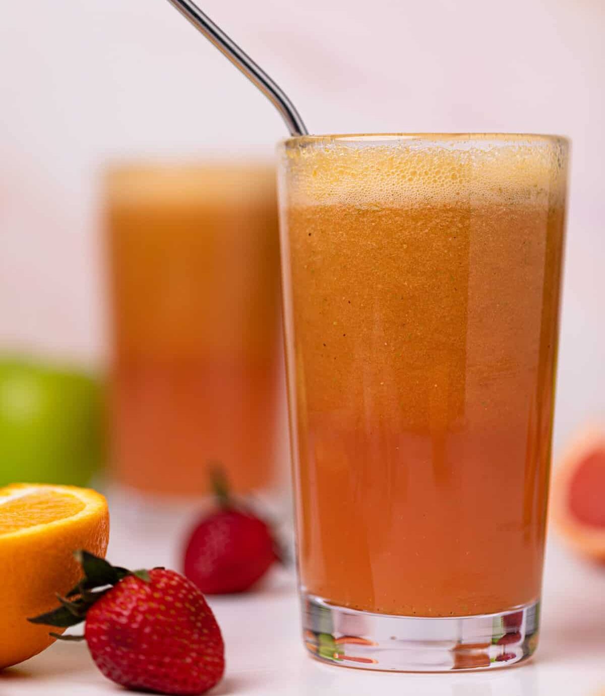 Apple Citrus Strawberry Juice in two glasses with a metal straw