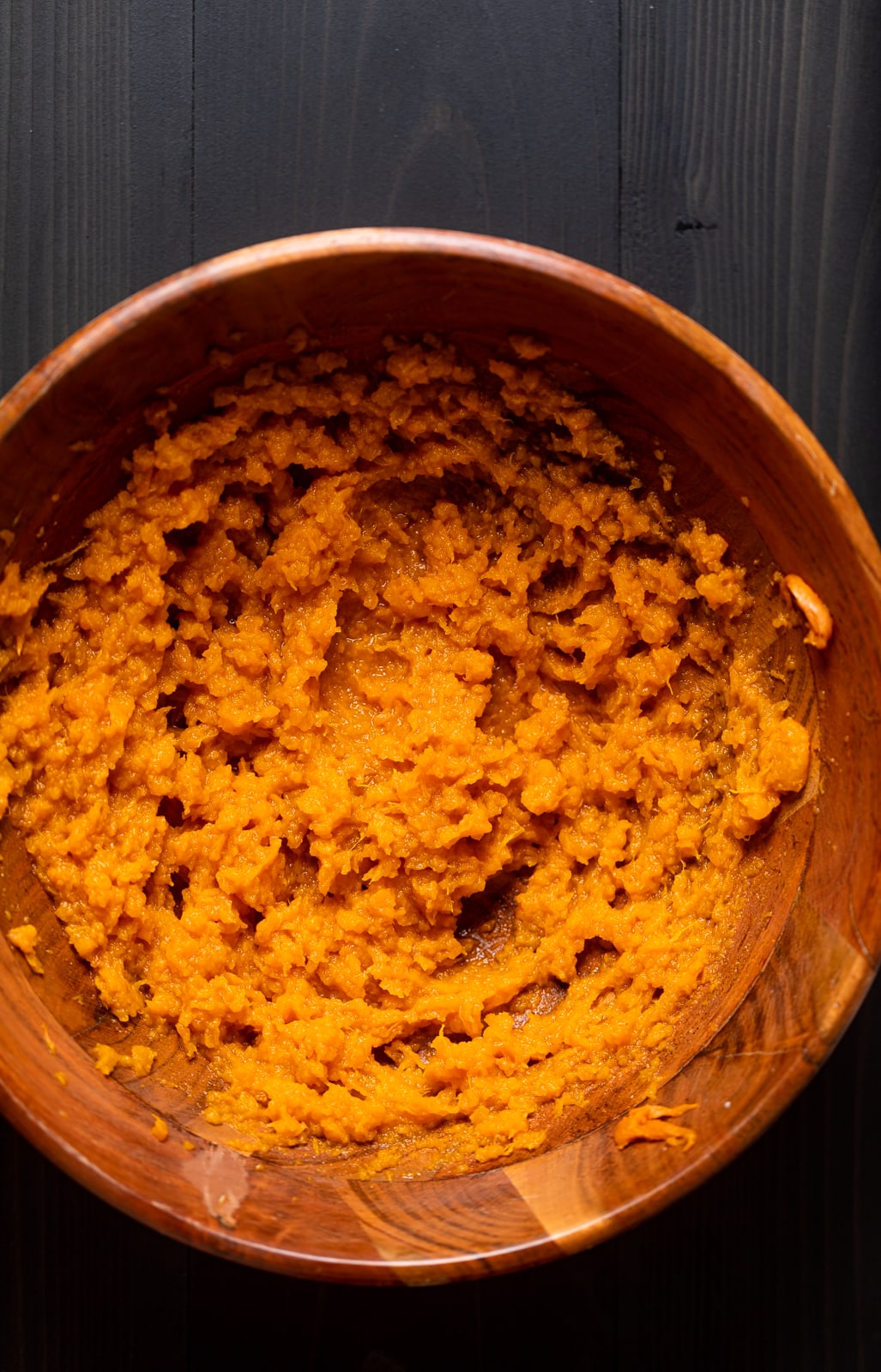 Wooden bowl of sweet potato puree.