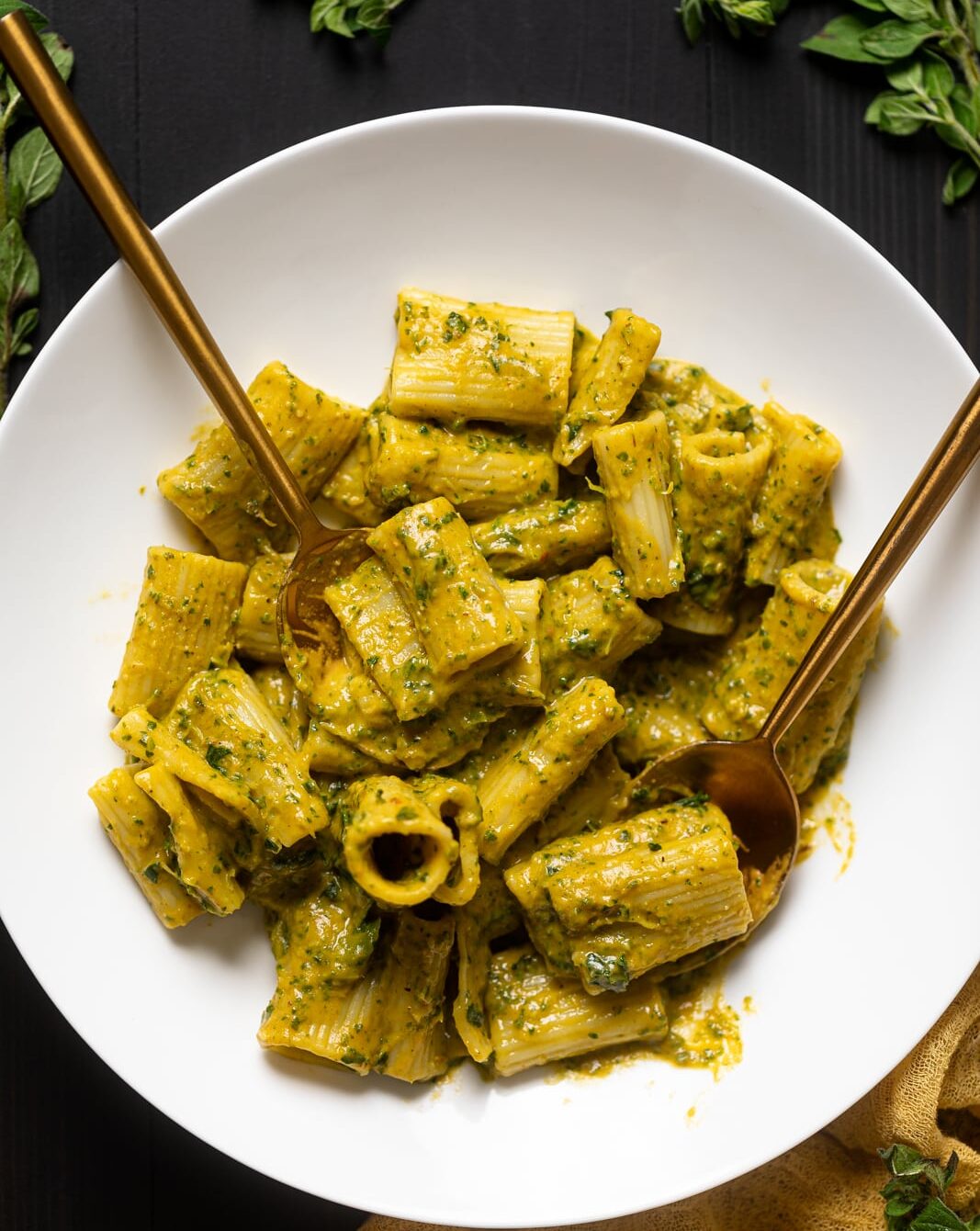 Golden silverware on a plate with Creamy Vegan Sweet Potato Pasta.