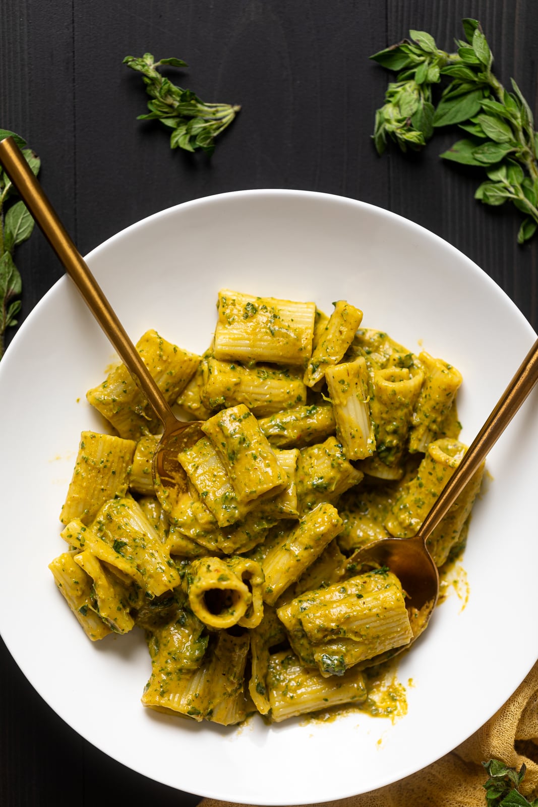 Golden silverware on a plate with Creamy Vegan Sweet Potato Pasta.