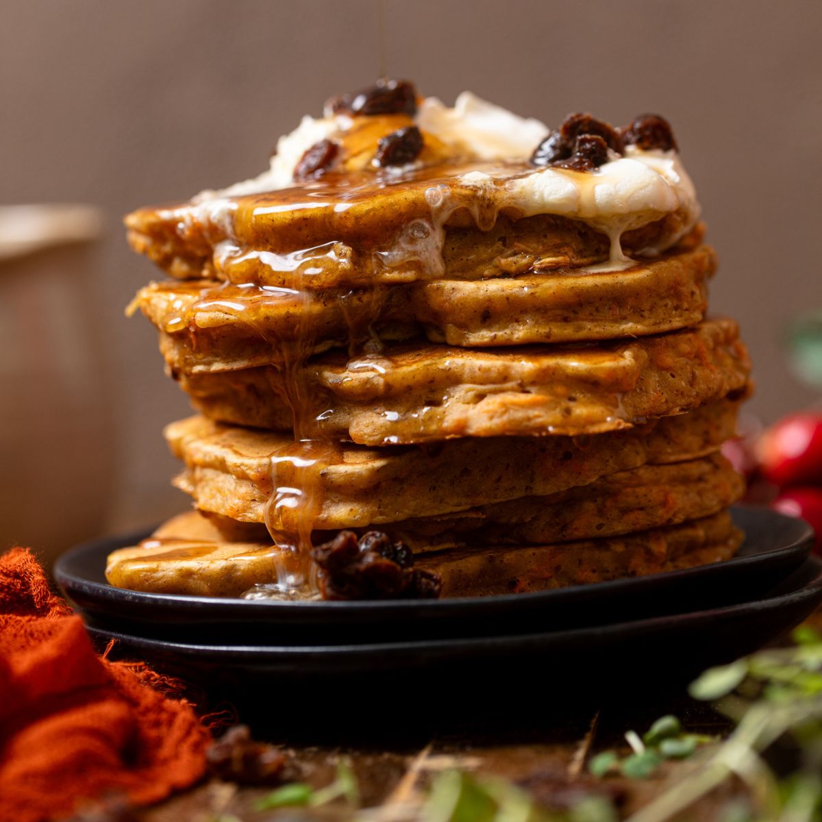 Up close shot of The Best Vegan Carrot Cake Pancakes stacked.