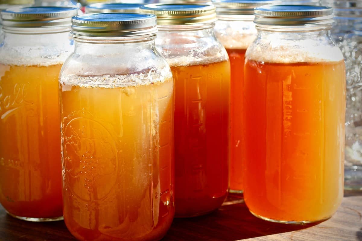 Canning jars of apple cider vinegar.