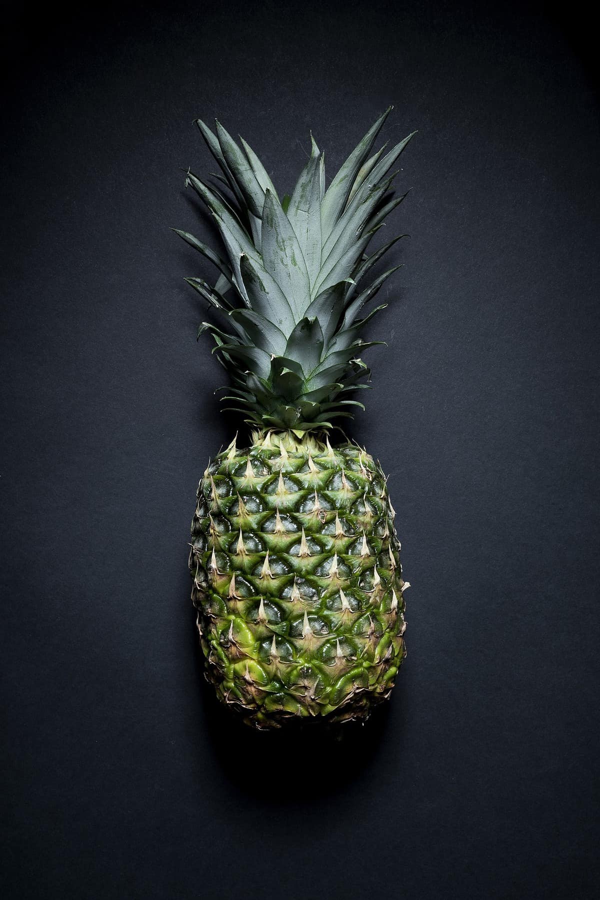 Pineapple on a black surface.