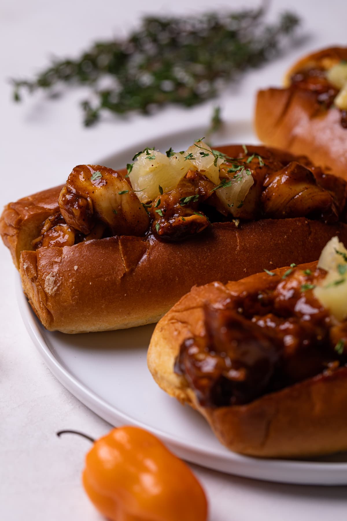 Spicy and Sweet barbeque Jerk Lobster Rolls on a white plate.