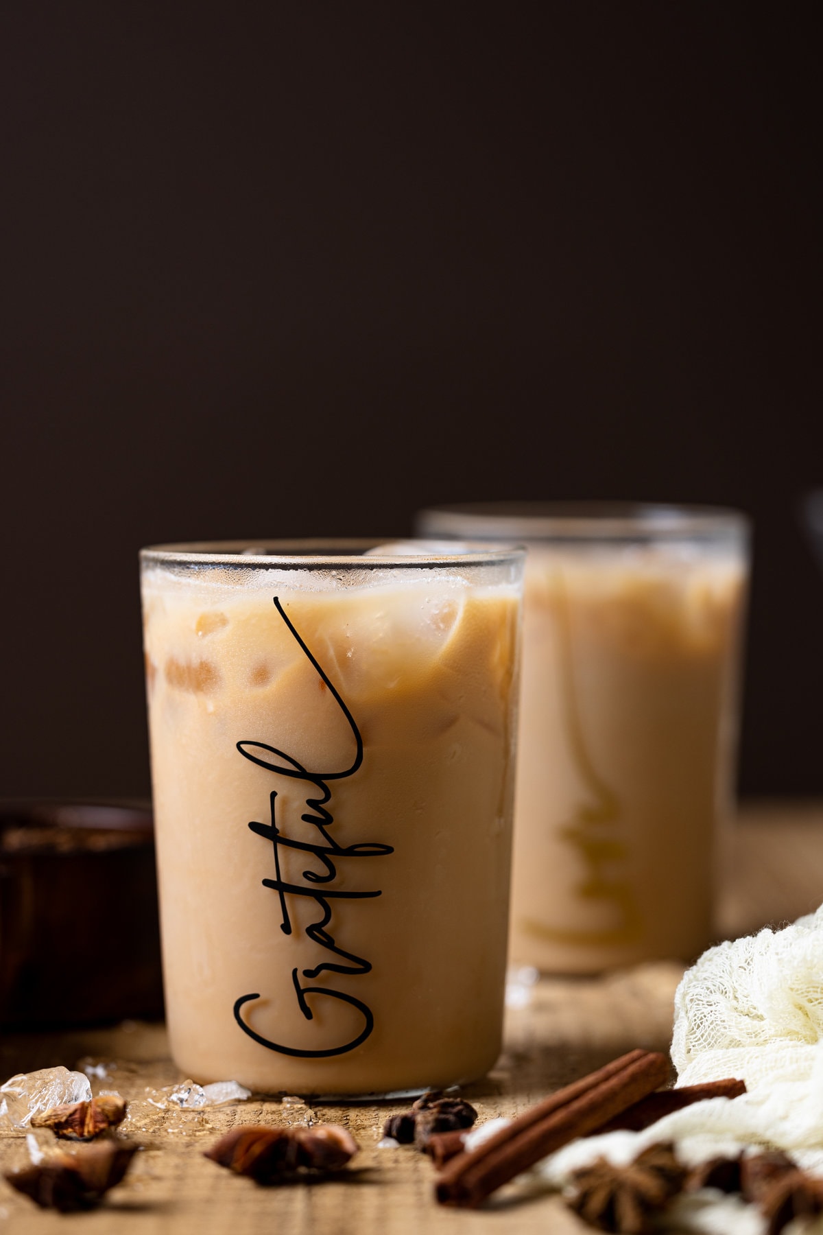 Iced Chai Tea Latte in a glass that reads \"Grateful\" in script lettering