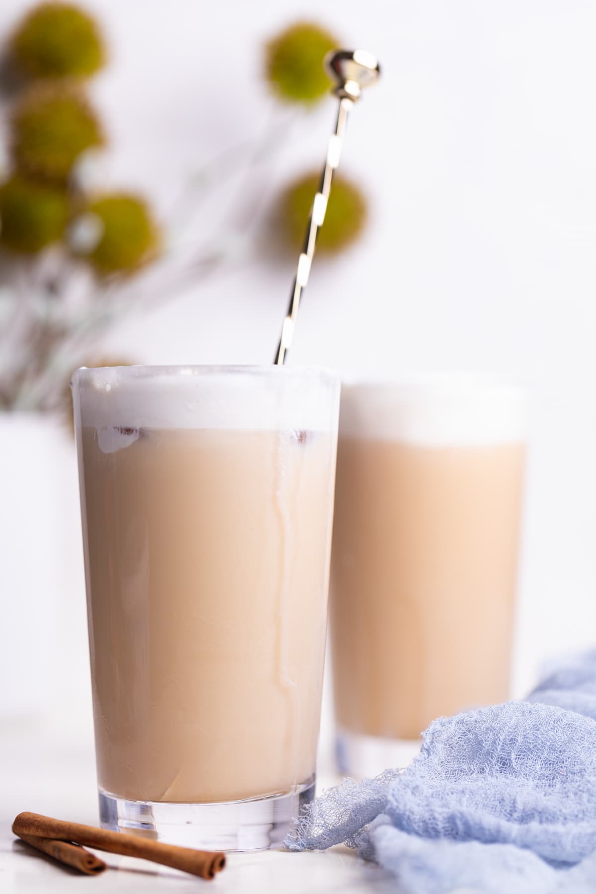 Two Iced Chai Tea Lattes in tall glasses