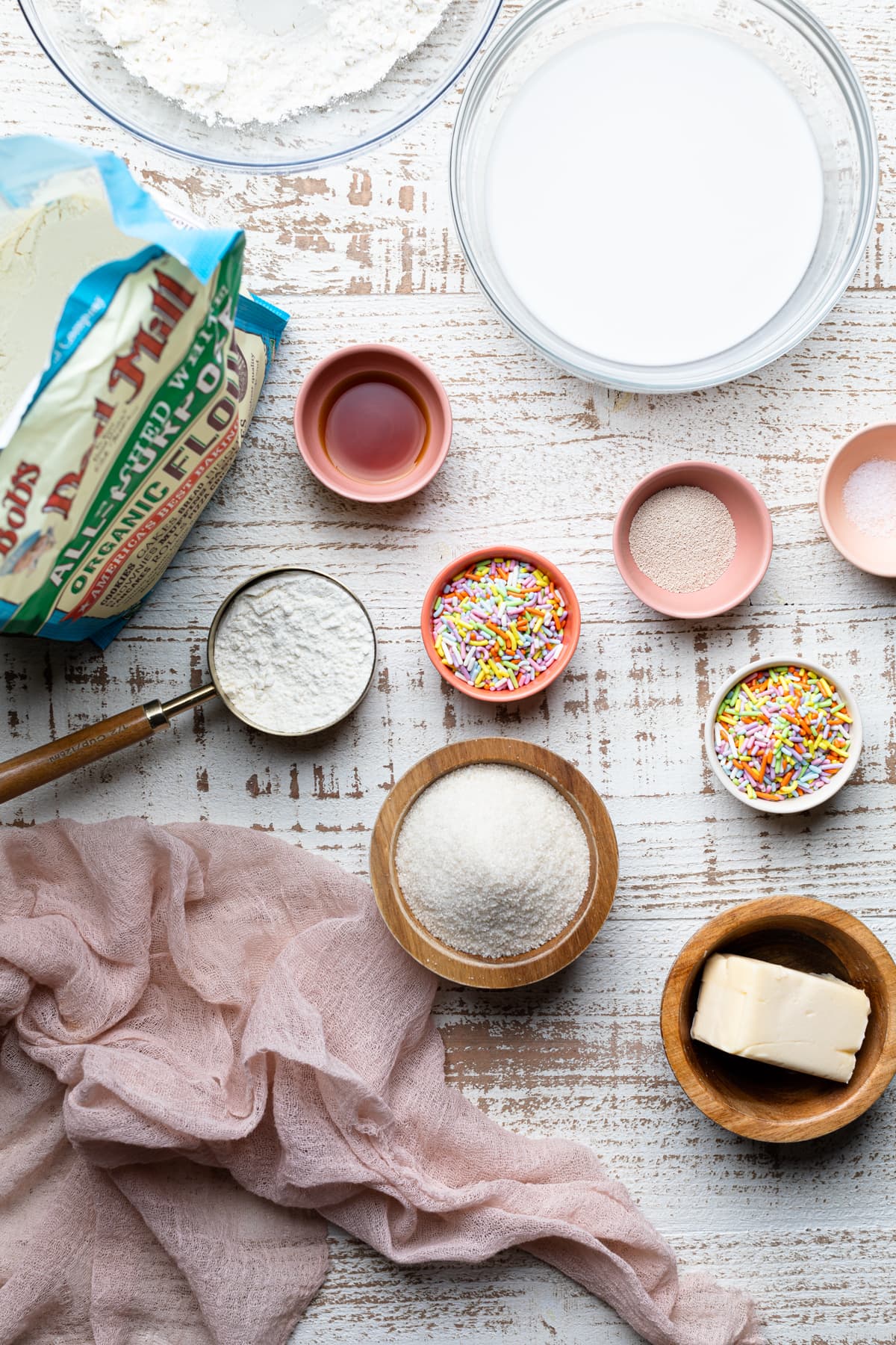 Ingredients for Vegan Funfetti Cinnamon Rolls including sprinkles, sugar, and Bob\'s Red Mill Flour.