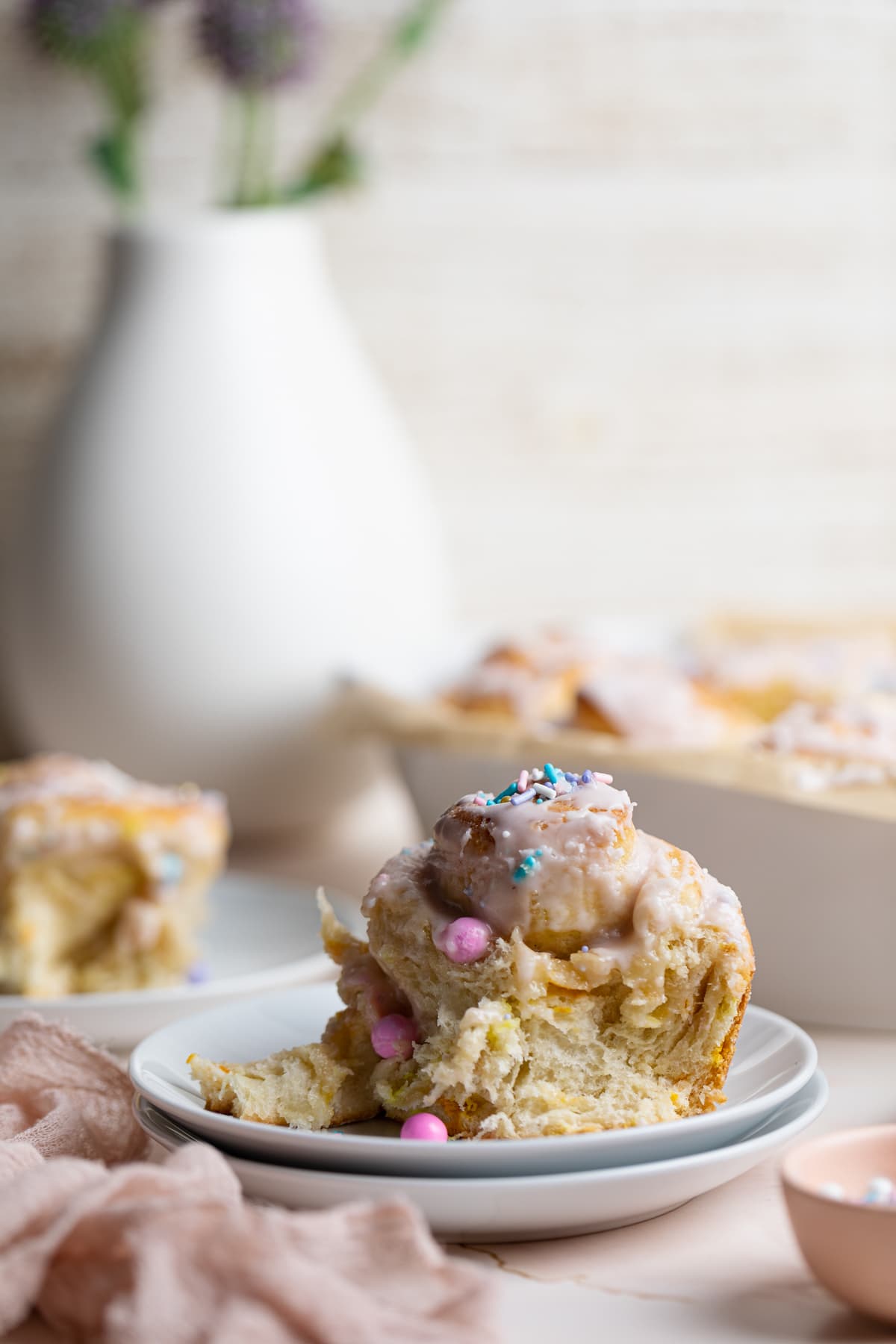 Vegan Funfetti Cinnamon Rolls on small plates.