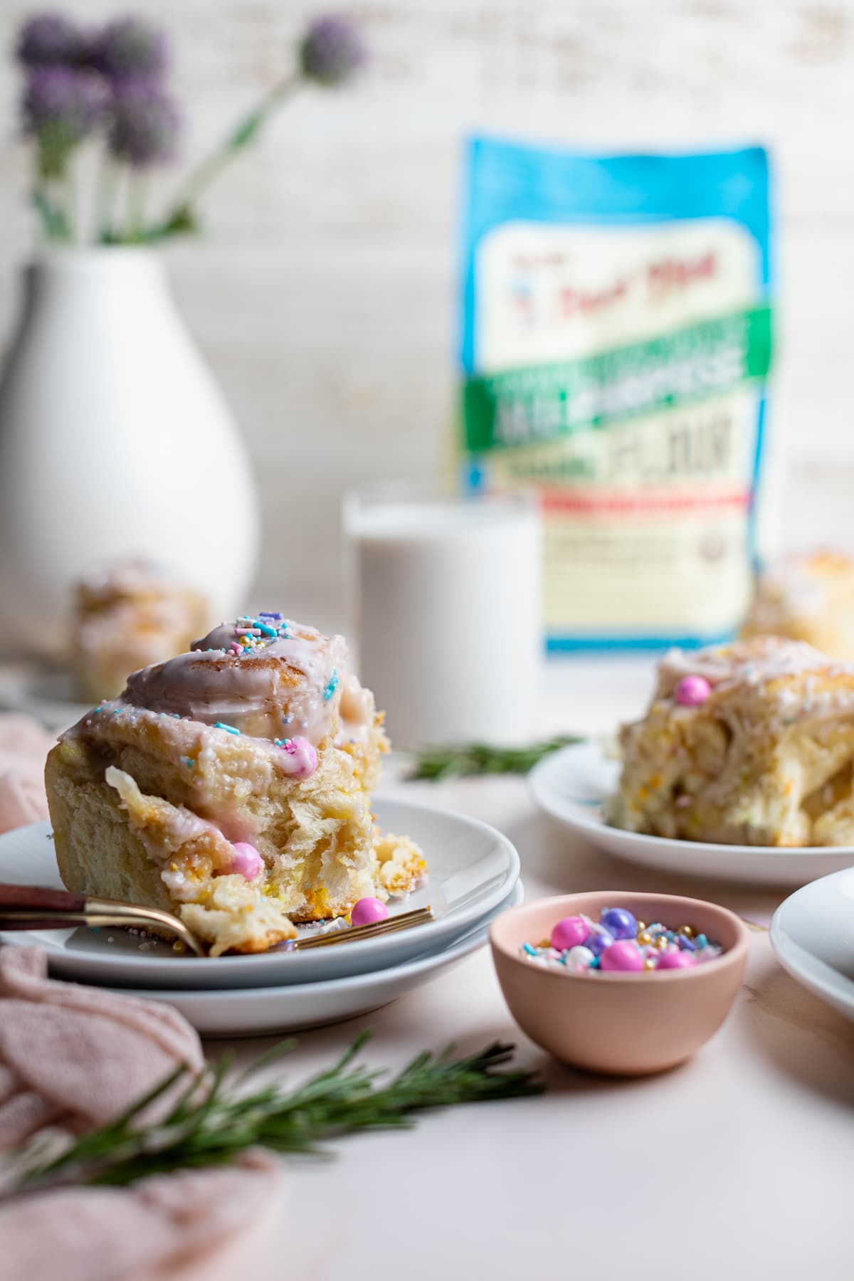 Vegan Funfetti Cinnamon Rolls on small plates.