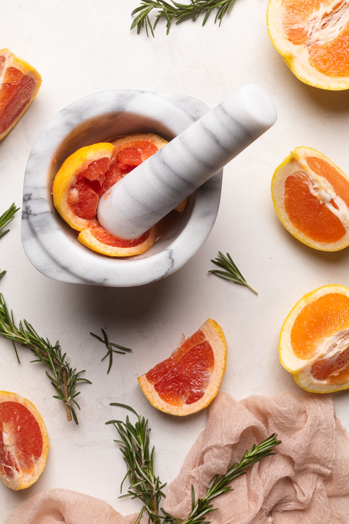 Grapefruit being smashed with a mortar and pestle.