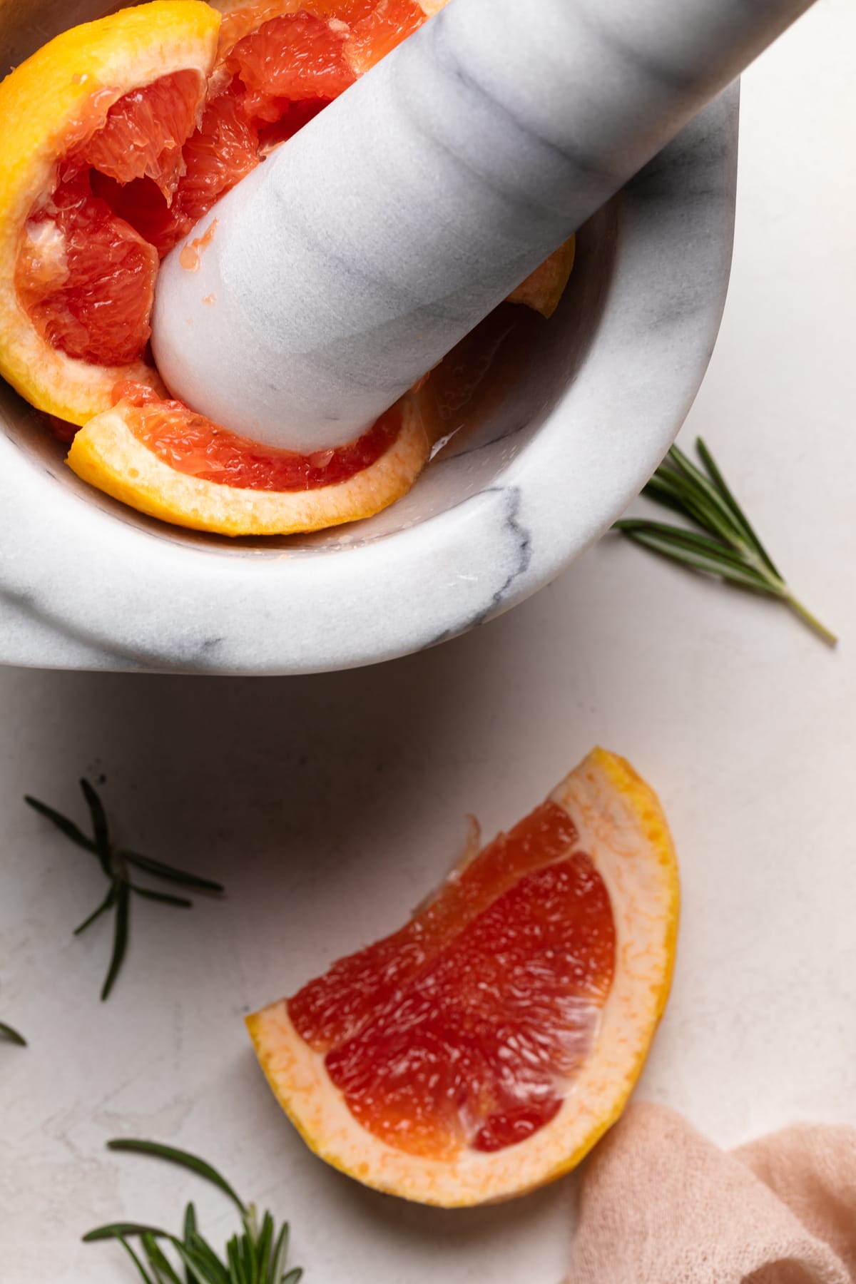 Mortar and pestle with a smashed grapefruit.