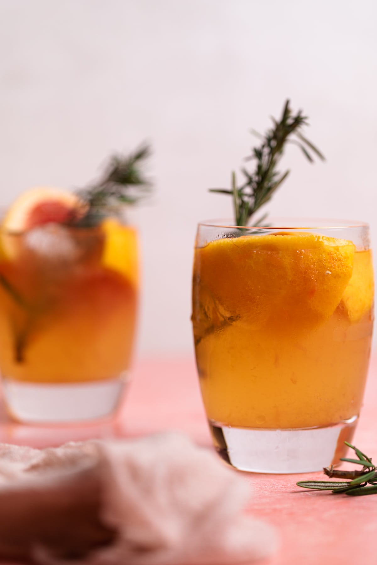 Two small glasses of Grapefruit Apple Cider Vinegar Rosemary Detox drink.