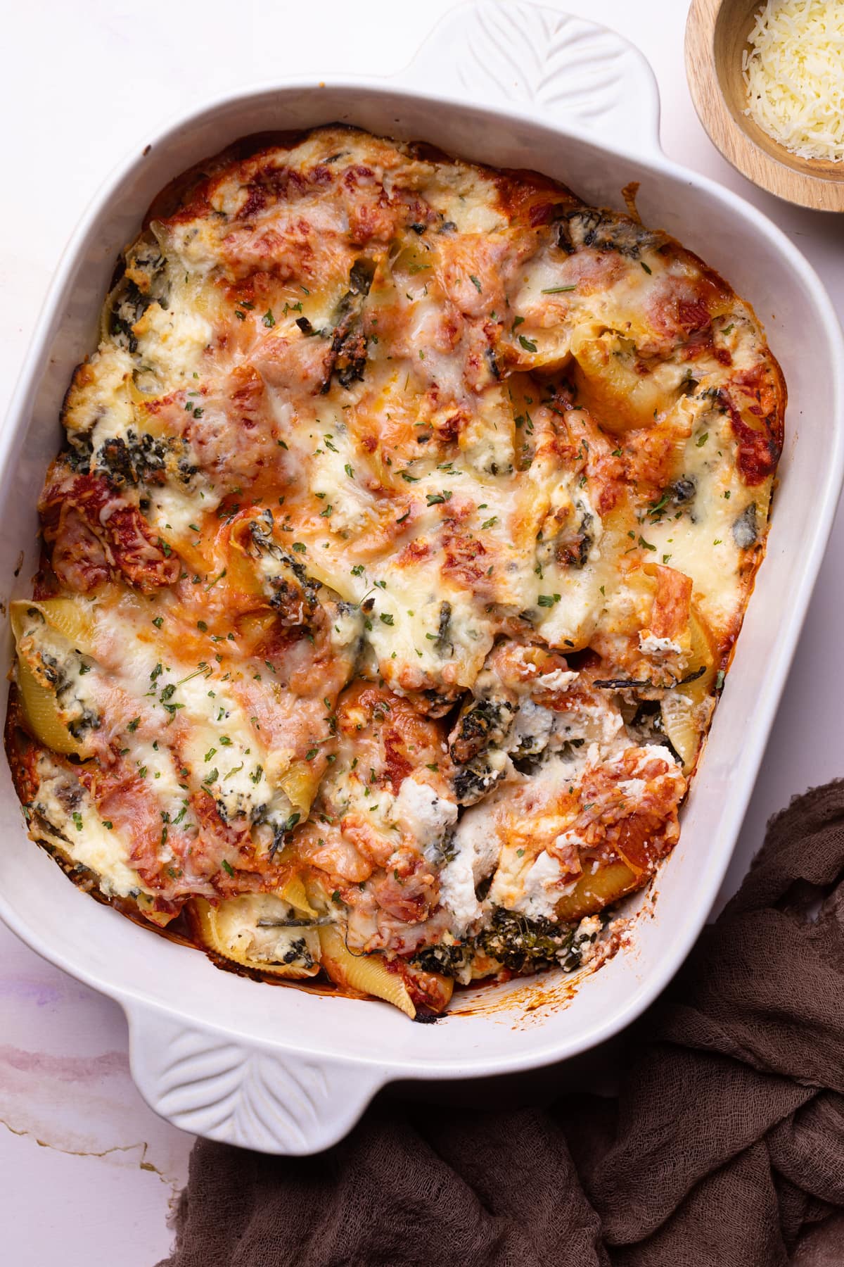 Roasted Broccolini and Chicken Ricotta Stuffed Shells in a white dish.