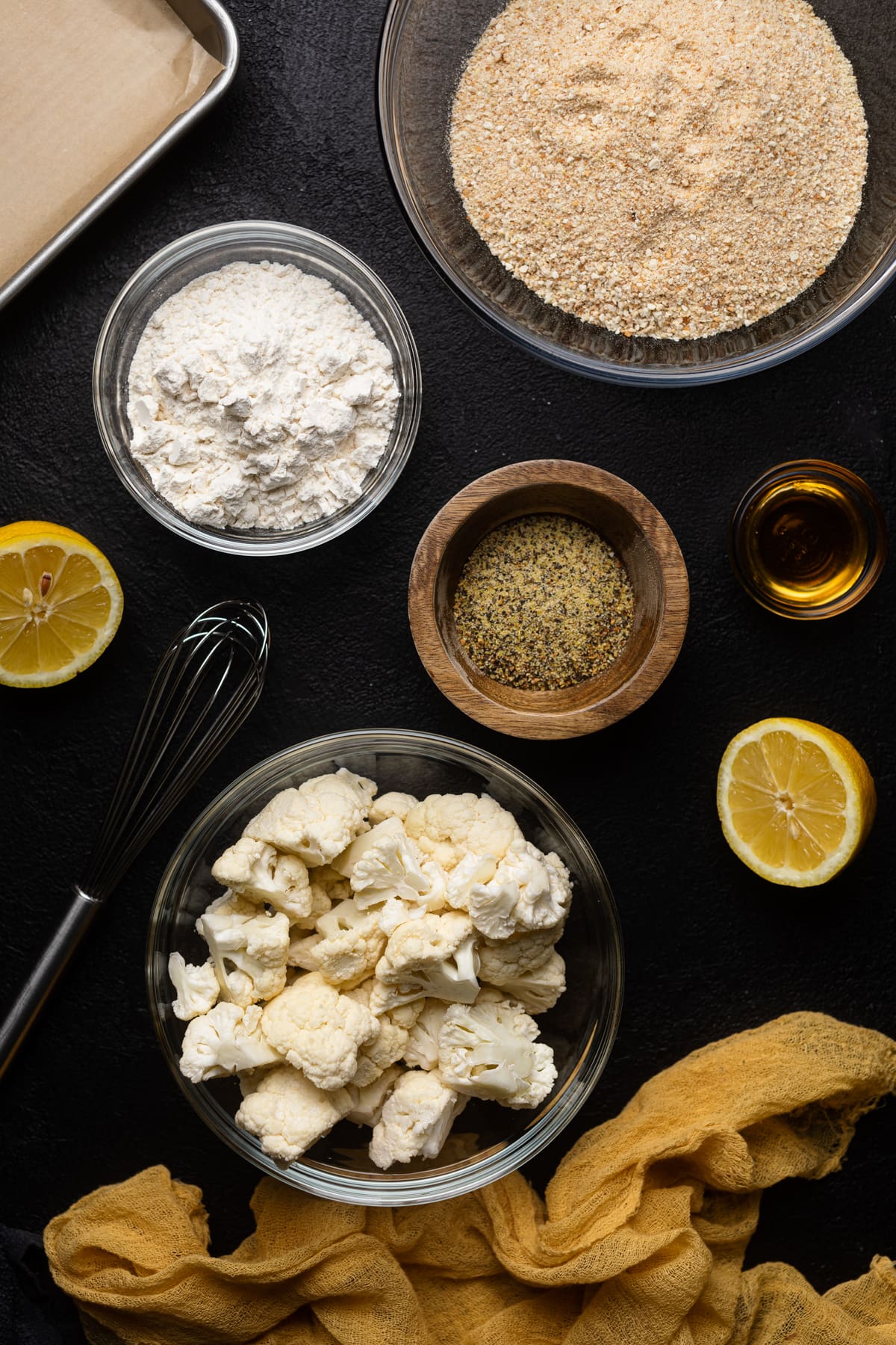 Ingredients for Lemon Pepper Cauliflower Bites including cauliflower, flour, bread crumbs, and lemon pepper seasoning.