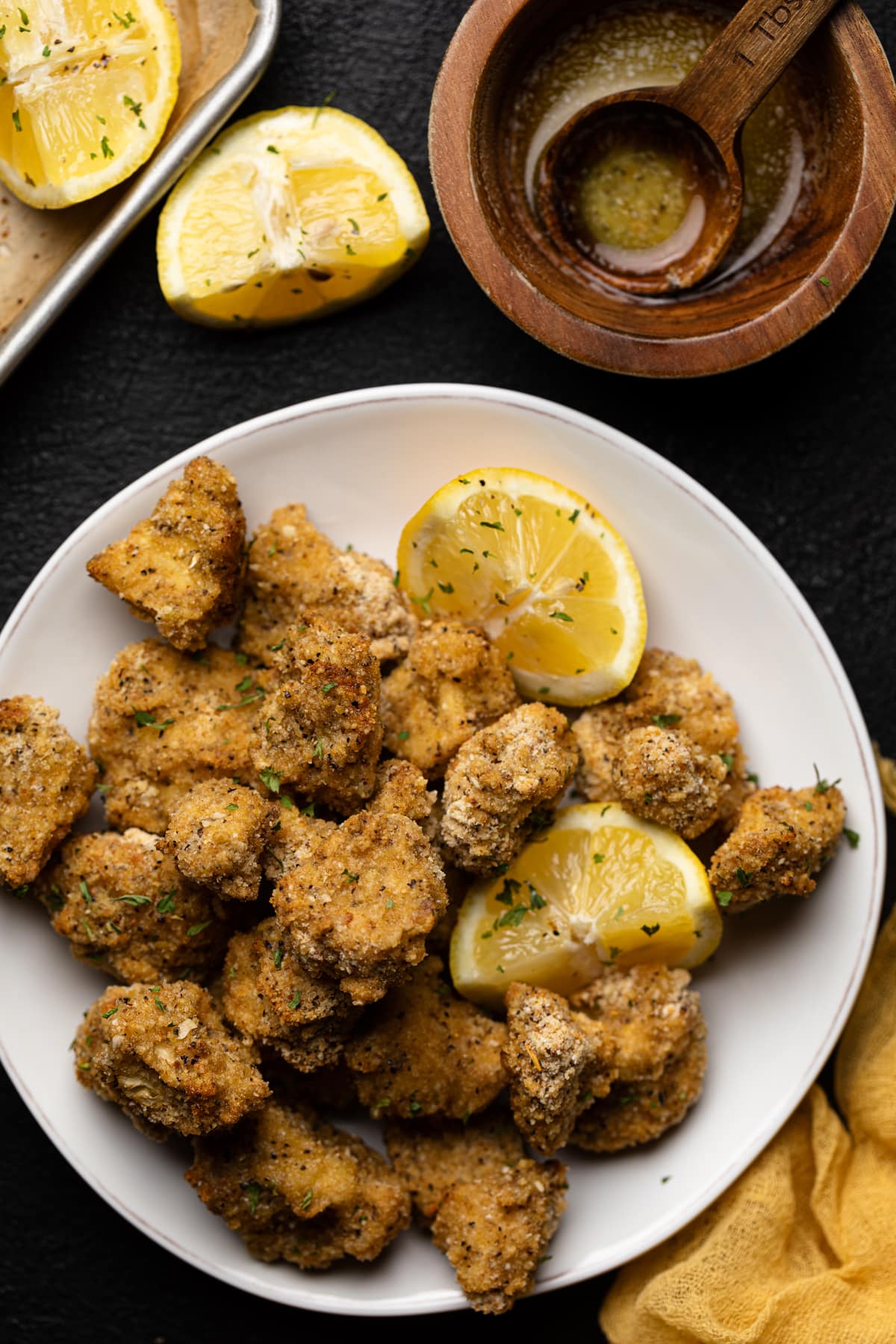 Plate of Lemon Pepper Cauliflower Bites and lemon wedges