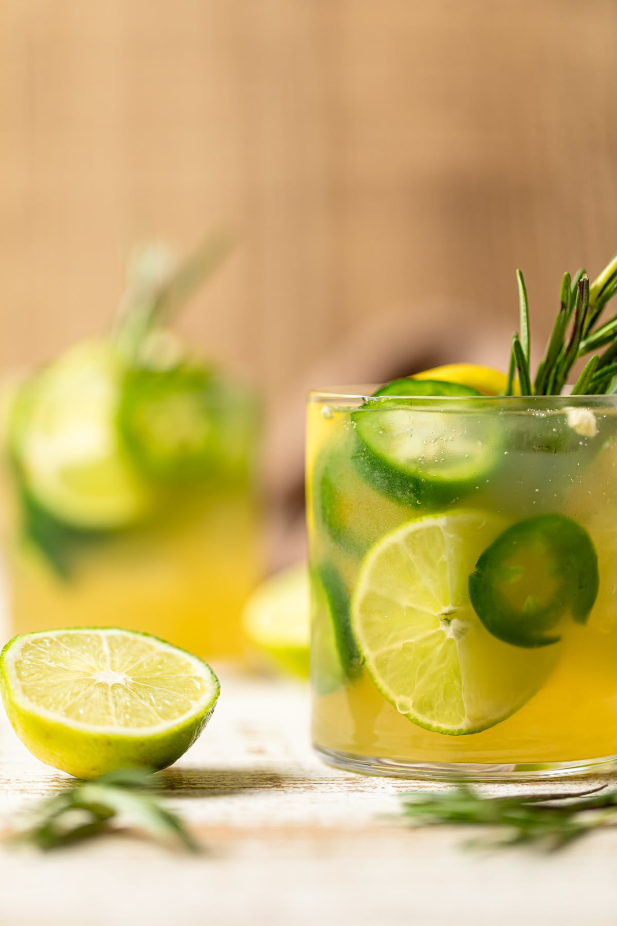 Jalapeno Lemon-Lime Mocktail next to a halved lime.