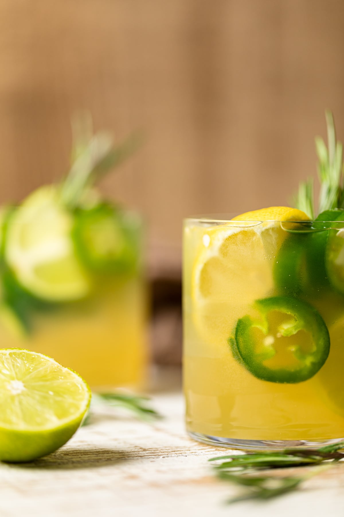 Two glass of Jalapeno Lemon-Lime Mocktail with a halved lime.