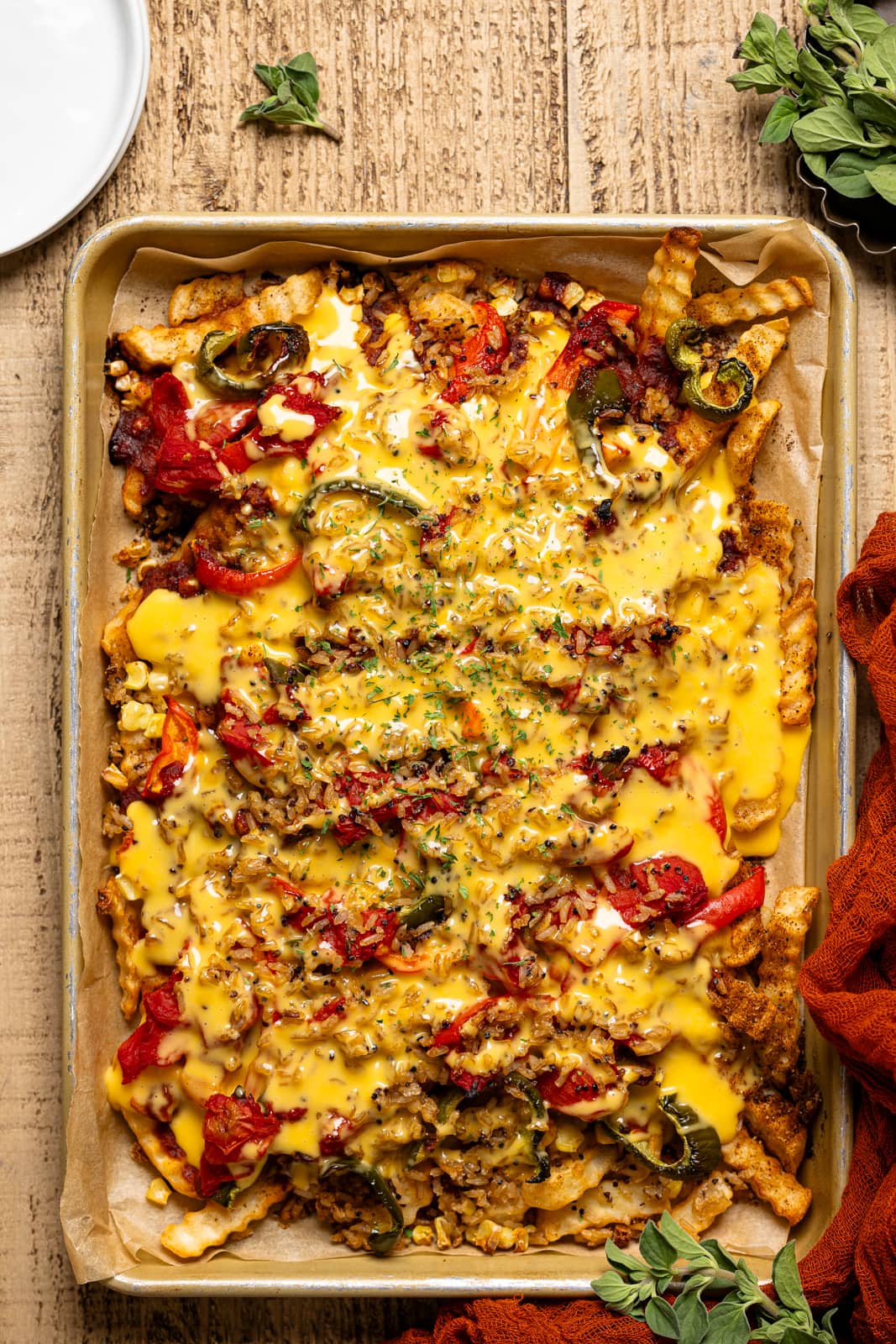 Baked loaded fries topped with melted dairy-free nacho cheese.
