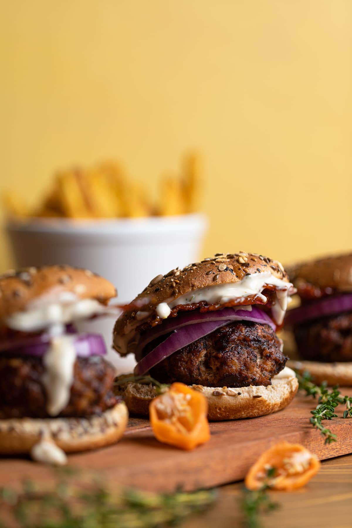 Dairy-Free barbeque Jerk Bacon Turkey Burgers on a wooden board.