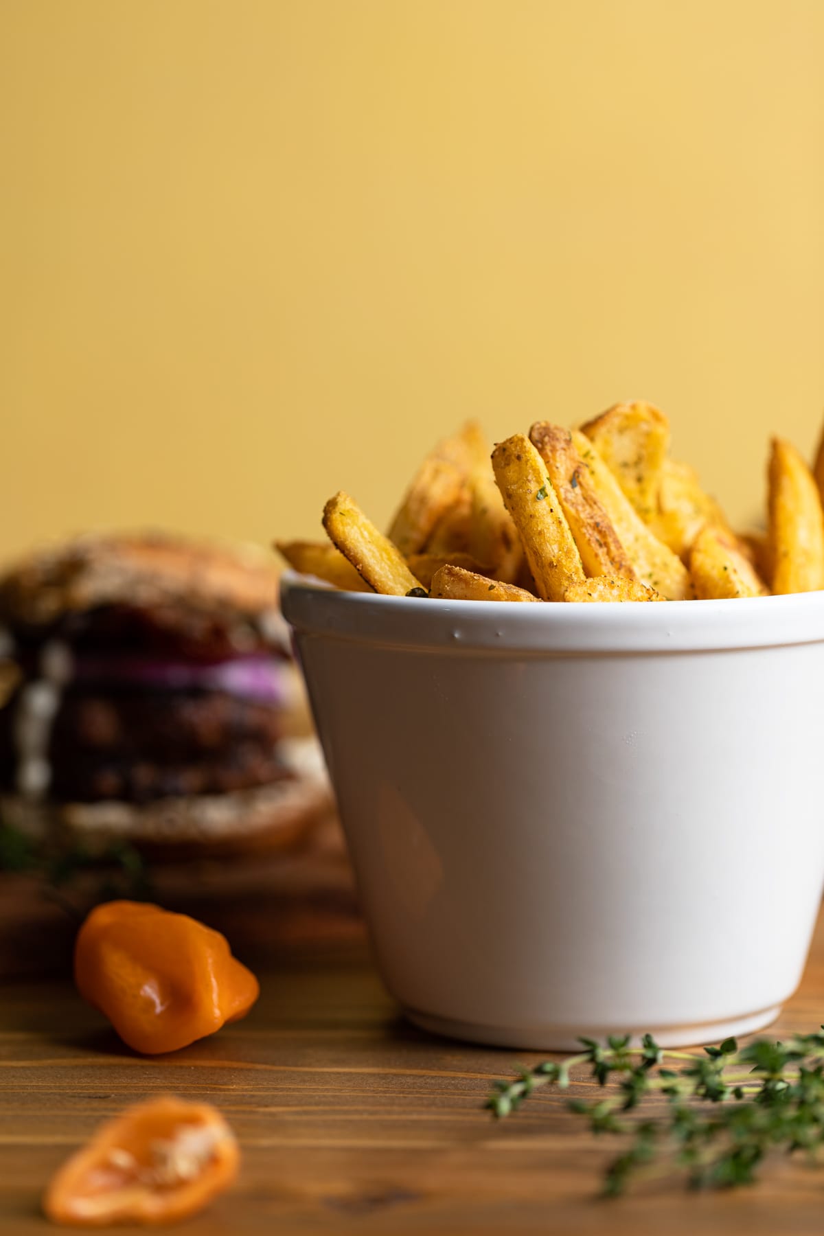 Bowl of fries with a Dairy-Free barbeque Jerk Bacon Turkey Burger.