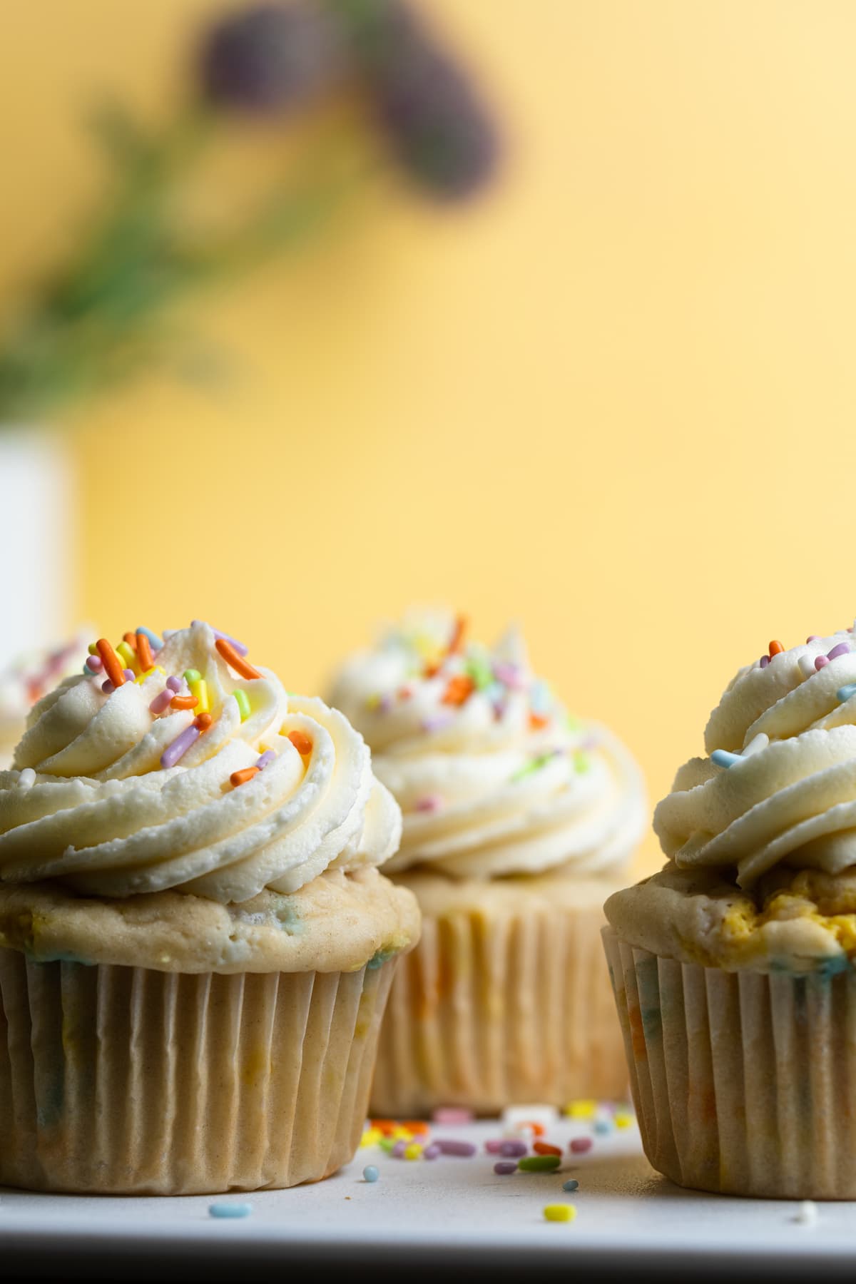 Vegan Funfetti Cupcakes topped with frosting and sprinkles.