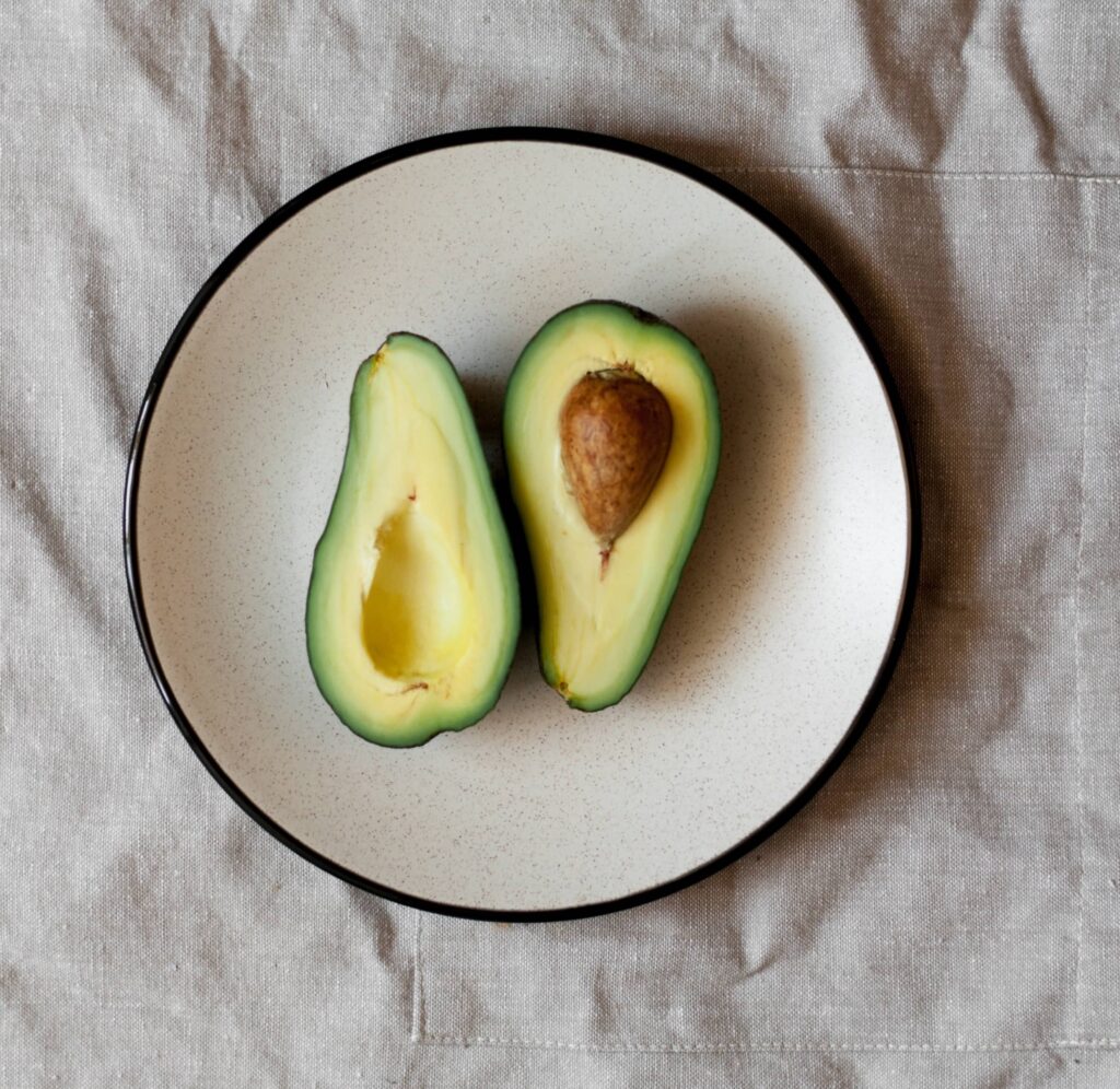 Halved avocado on a plate.