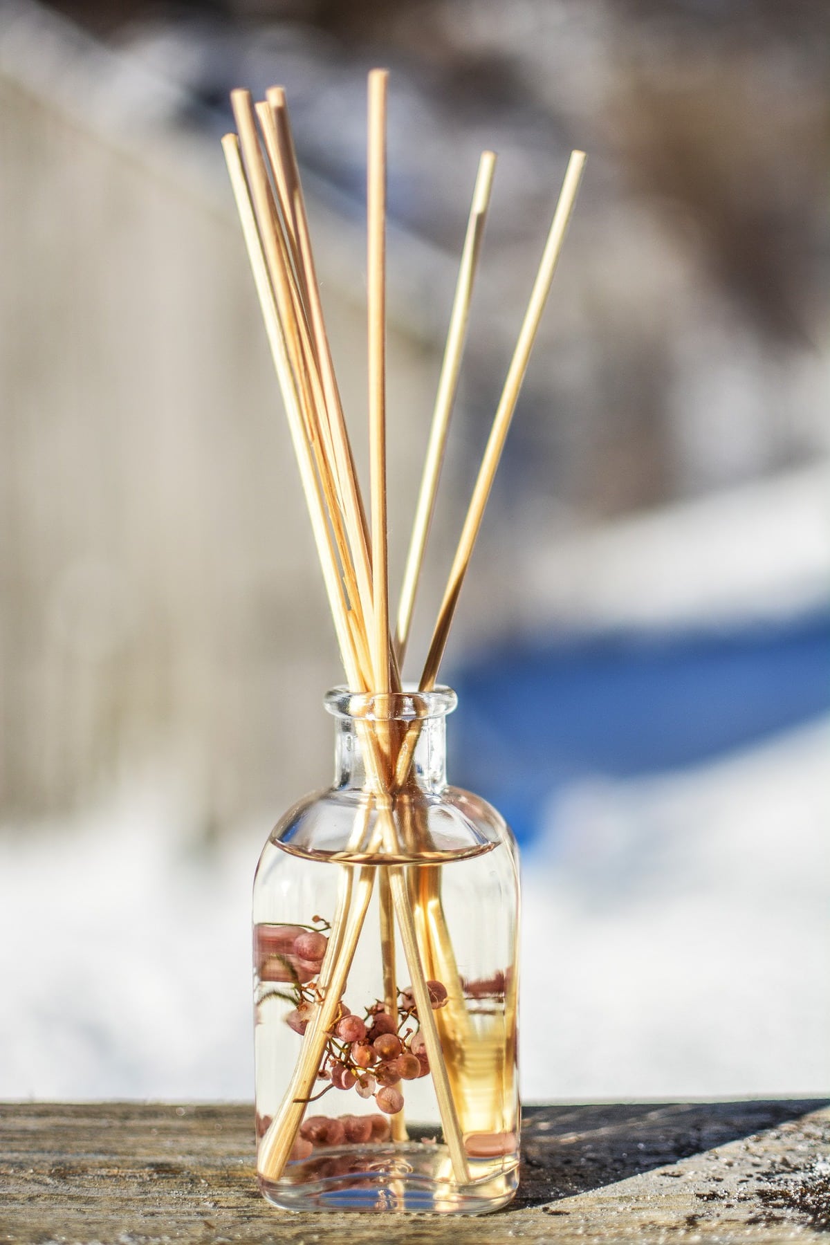 Diffuser reeds sticking out of a jar of oil.