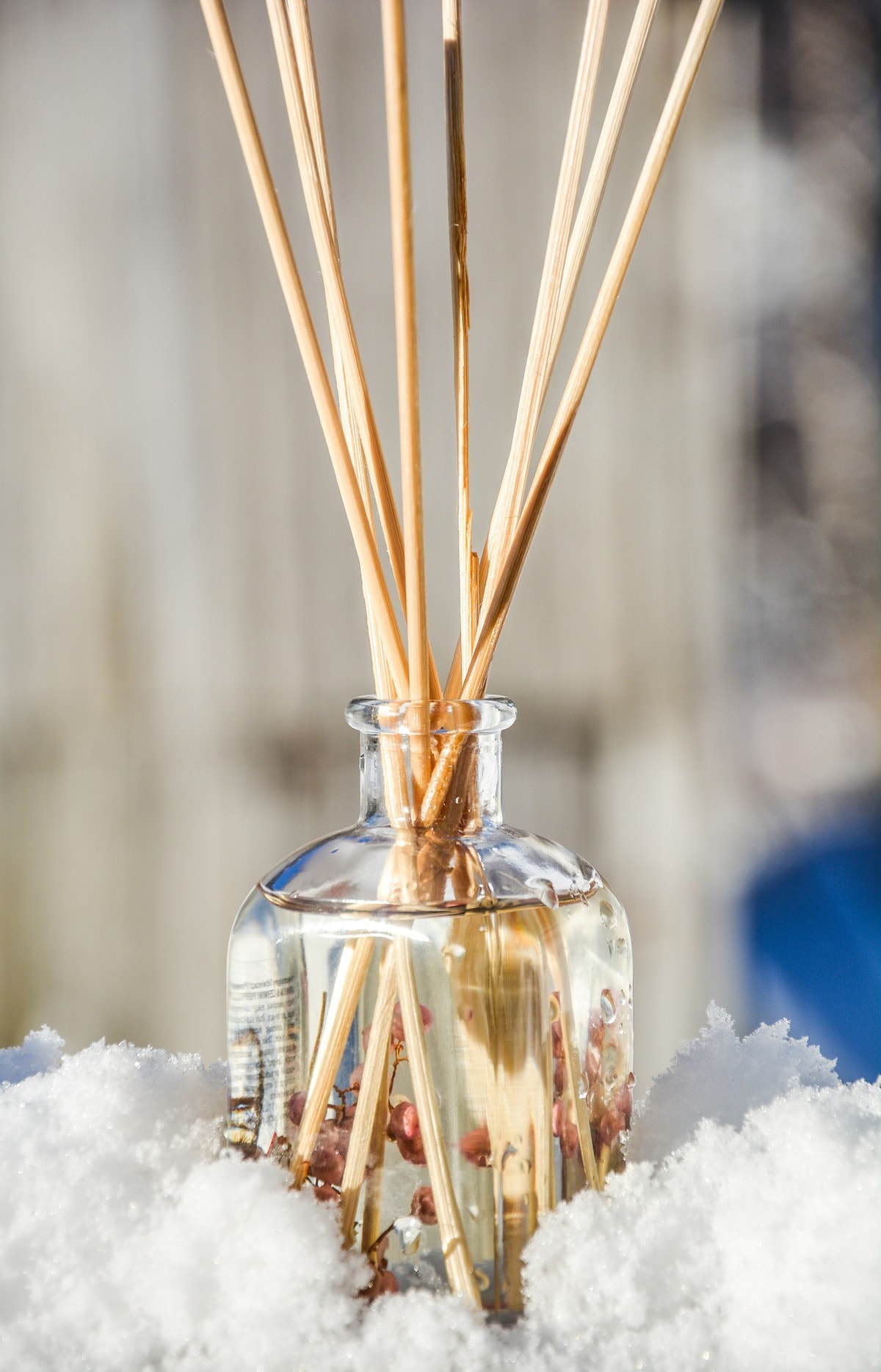 Reed diffusers in a clear jar of oil.