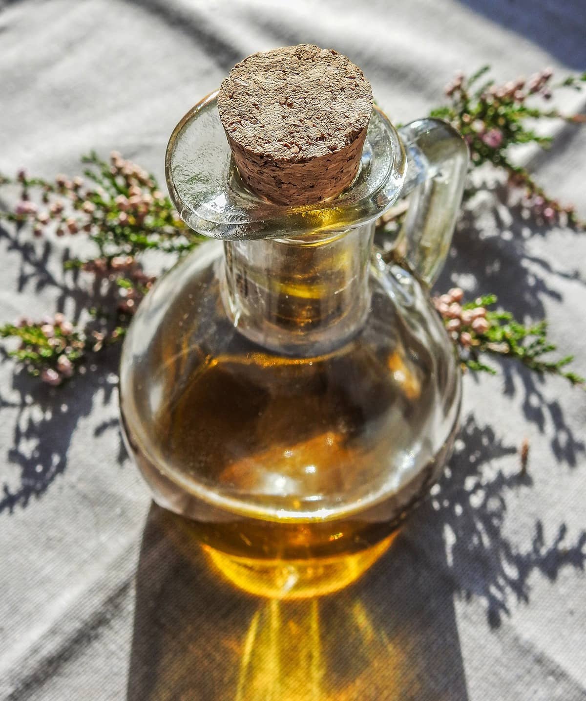 Oil in a jar with a cork stopper.