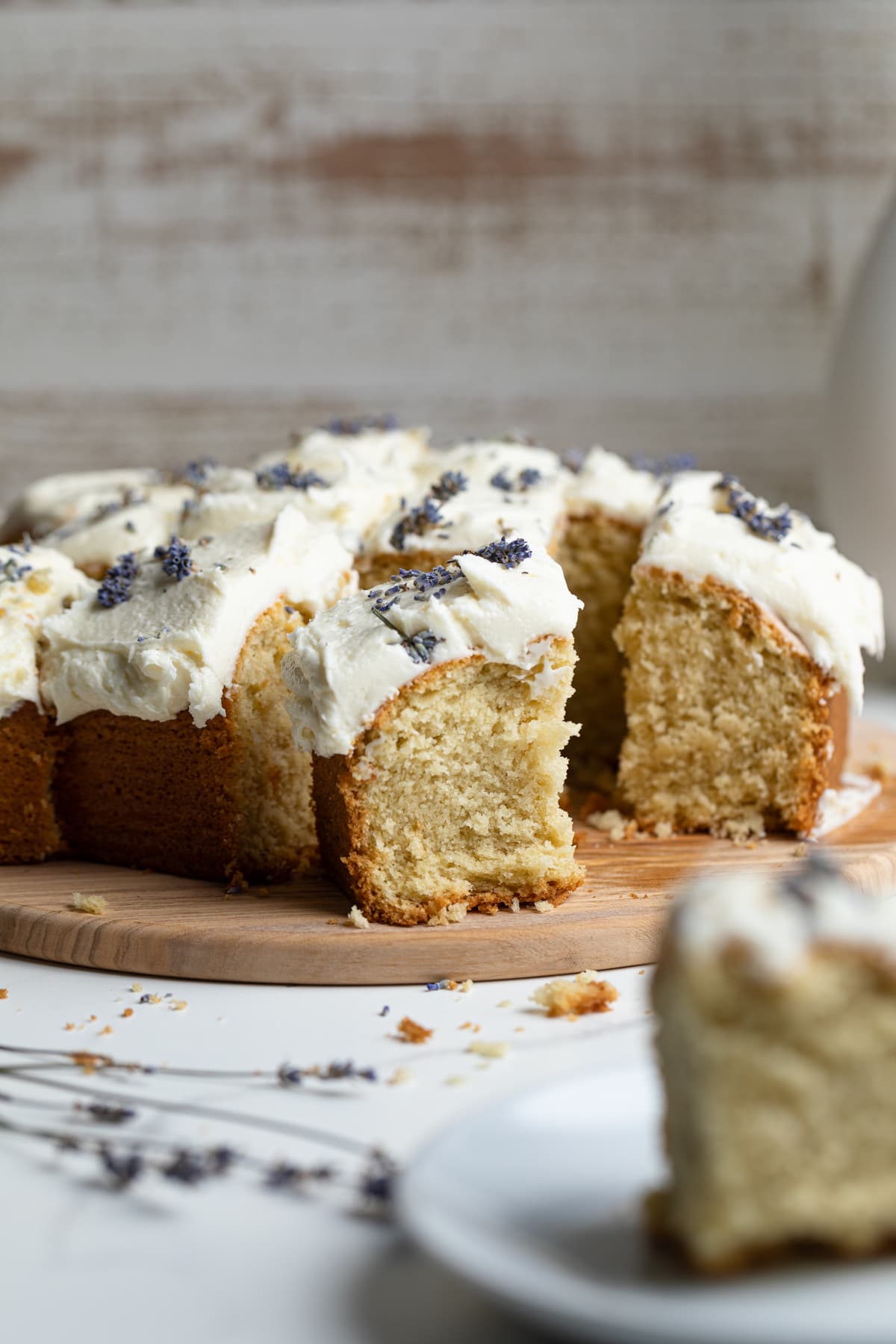 Side view of a sliced Chamomile Lavender and Honey Sheet Cake on a wooden board