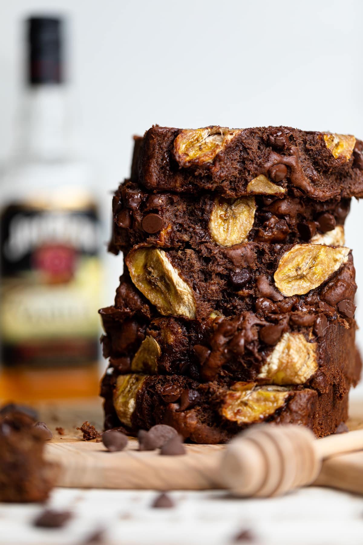 Five stacked slices of Vegan Chocolate Bourbon Banana Bread.