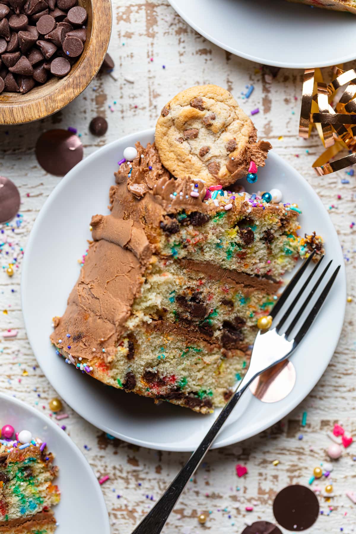 Slice of Confetti Chocolate Chip Cake on a plate with a fork.