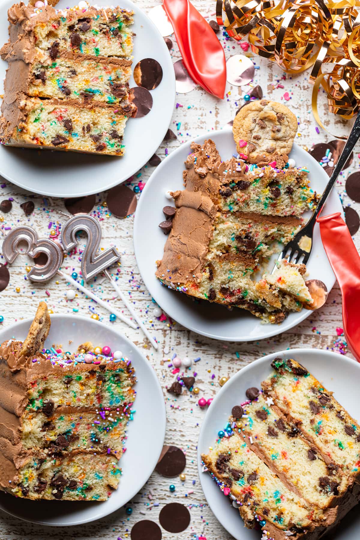 Slices of Confetti Chocolate Chip Cake on small, white plates.